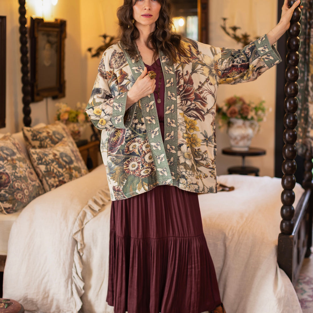 
                  
                    Model wearing a soft cotton velvet duster featuring lush 1700s botanical blooms and bumblebee trim - Market of Stars
                  
                