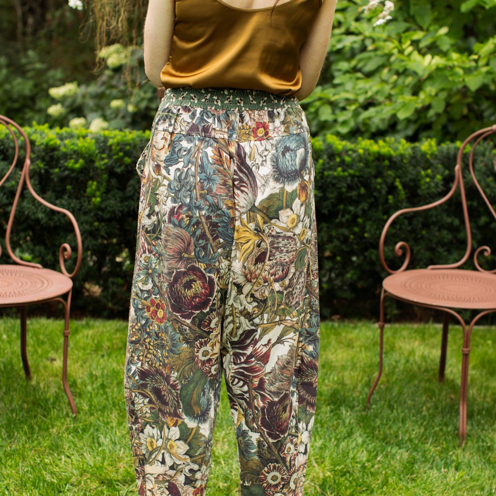 
                  
                    Model styled in Love Grows Wild Artist Pants featuring 1700s hand-coloured floral etchings and bumblebee trim – relaxed lantern hem and cropped fit – Market of Stars
                  
                