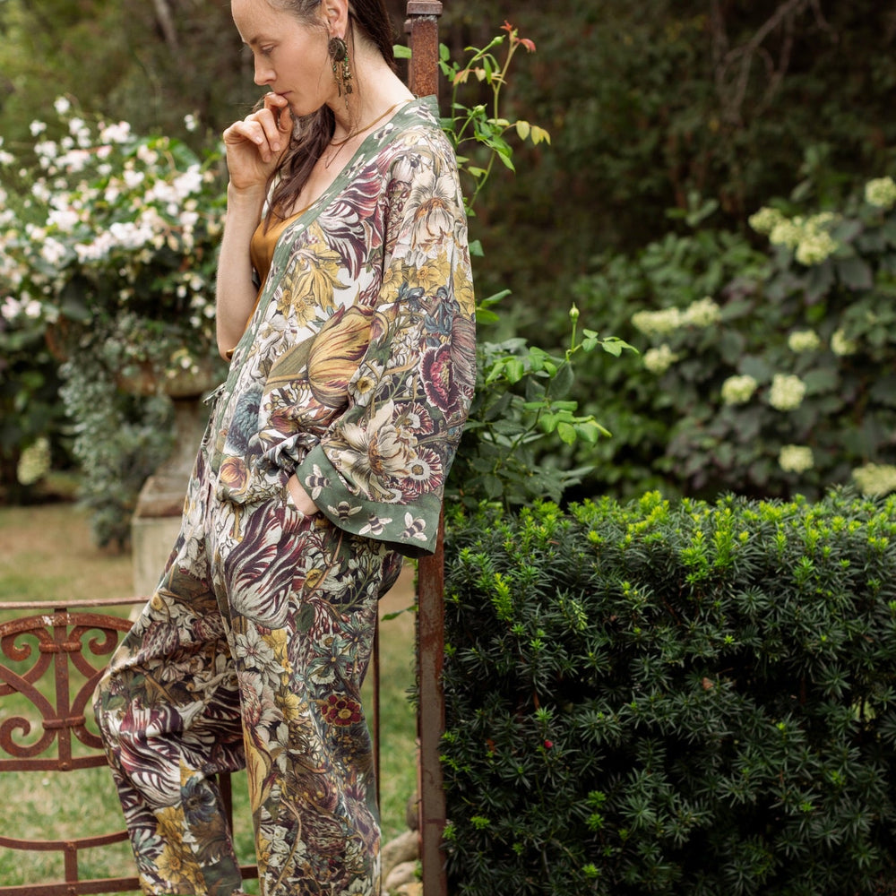 
                  
                    Model styled in Love Grows Wild Artist Pants featuring 1700s hand-coloured floral etchings and bumblebee trim – relaxed lantern hem and cropped fit – Market of Stars
                  
                