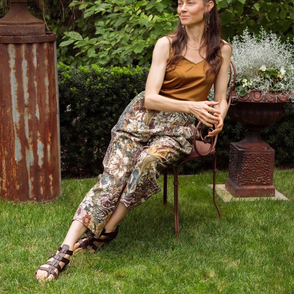 
                  
                    Model styled in Love Grows Wild Artist Pants featuring 1700s hand-coloured floral etchings and bumblebee trim – relaxed lantern hem and cropped fit – Market of Stars
                  
                
