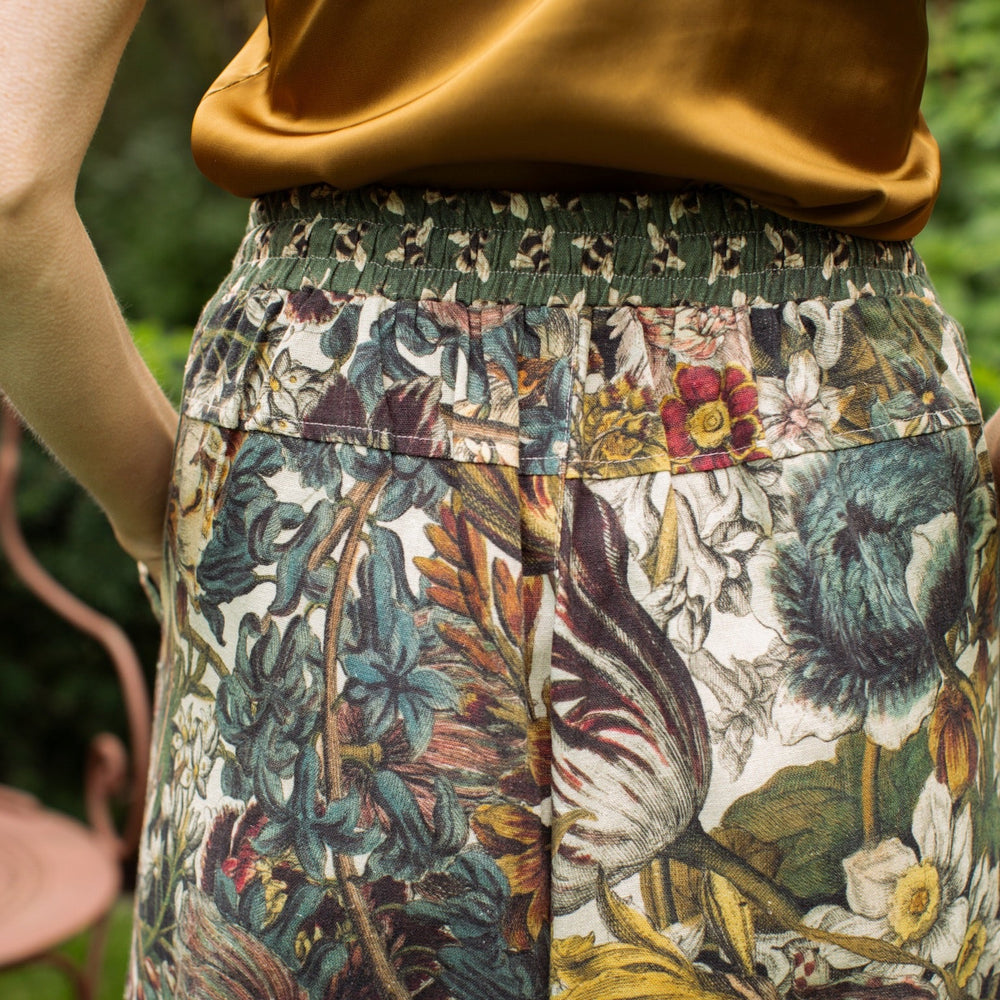
                  
                    Model styled in Love Grows Wild Artist Pants featuring 1700s hand-coloured floral etchings and bumblebee trim – relaxed lantern hem and cropped fit – Market of Stars
                  
                