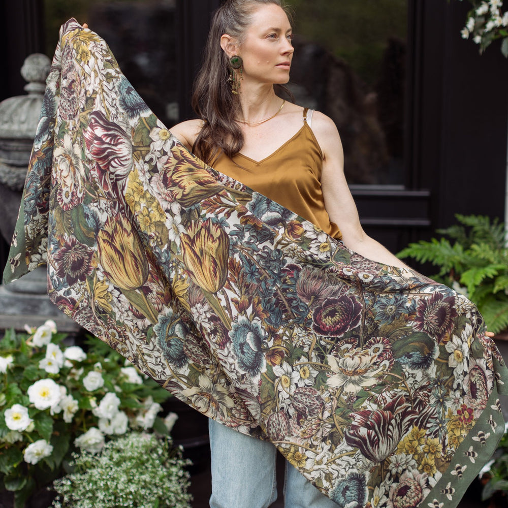 Model wearing soft viscose scarf featuring 1700s March botanical etchings and bumblebee trim from vintage seed catalogue – Market of Stars.