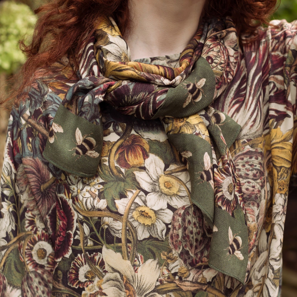 Model wearing soft viscose scarf featuring 1700s March botanical etchings and bumblebee trim from vintage seed catalogue – Market of Stars.