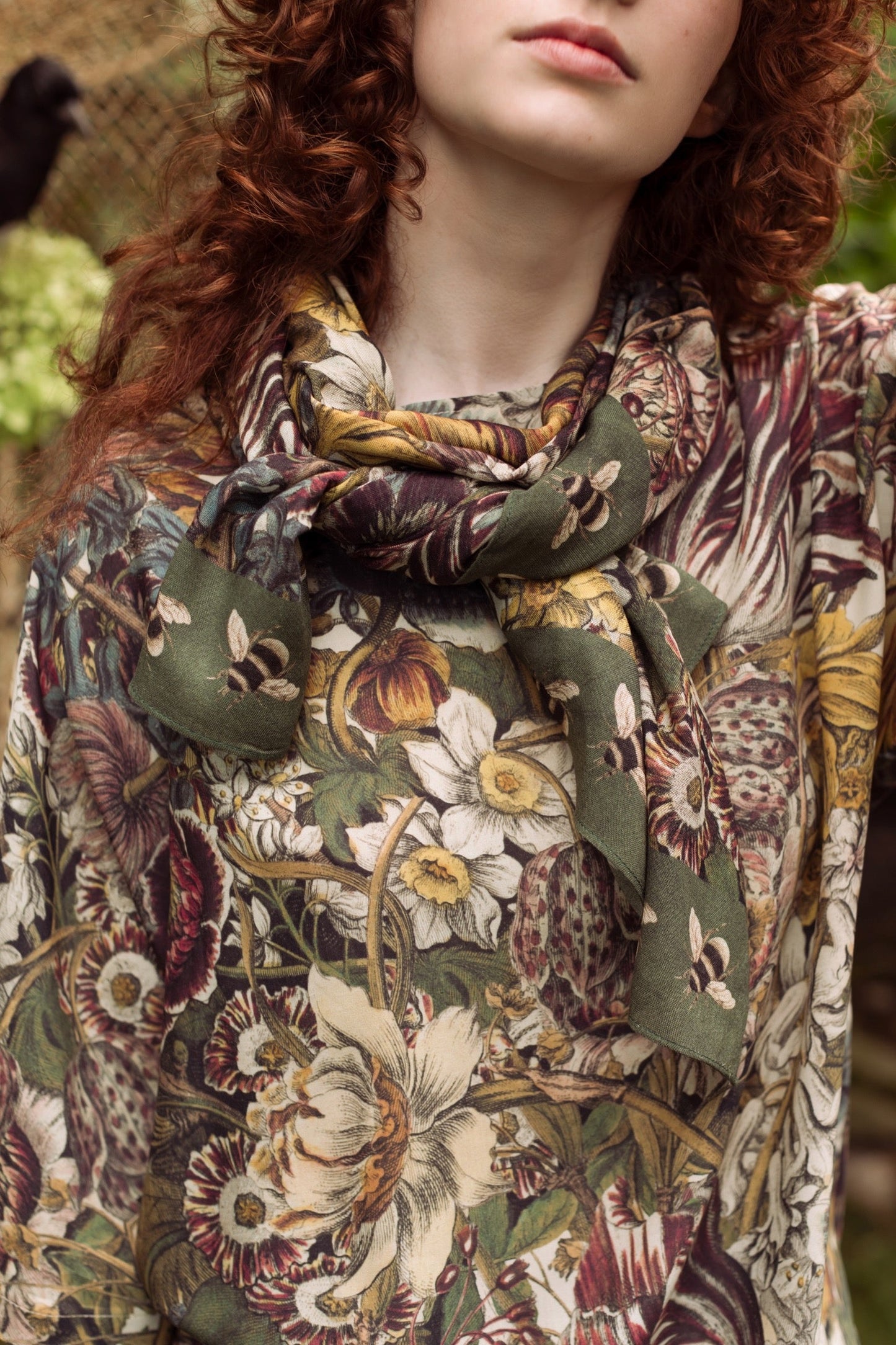 Model wearing soft viscose scarf featuring 1700s March botanical etchings and bumblebee trim from vintage seed catalogue – Market of Stars.