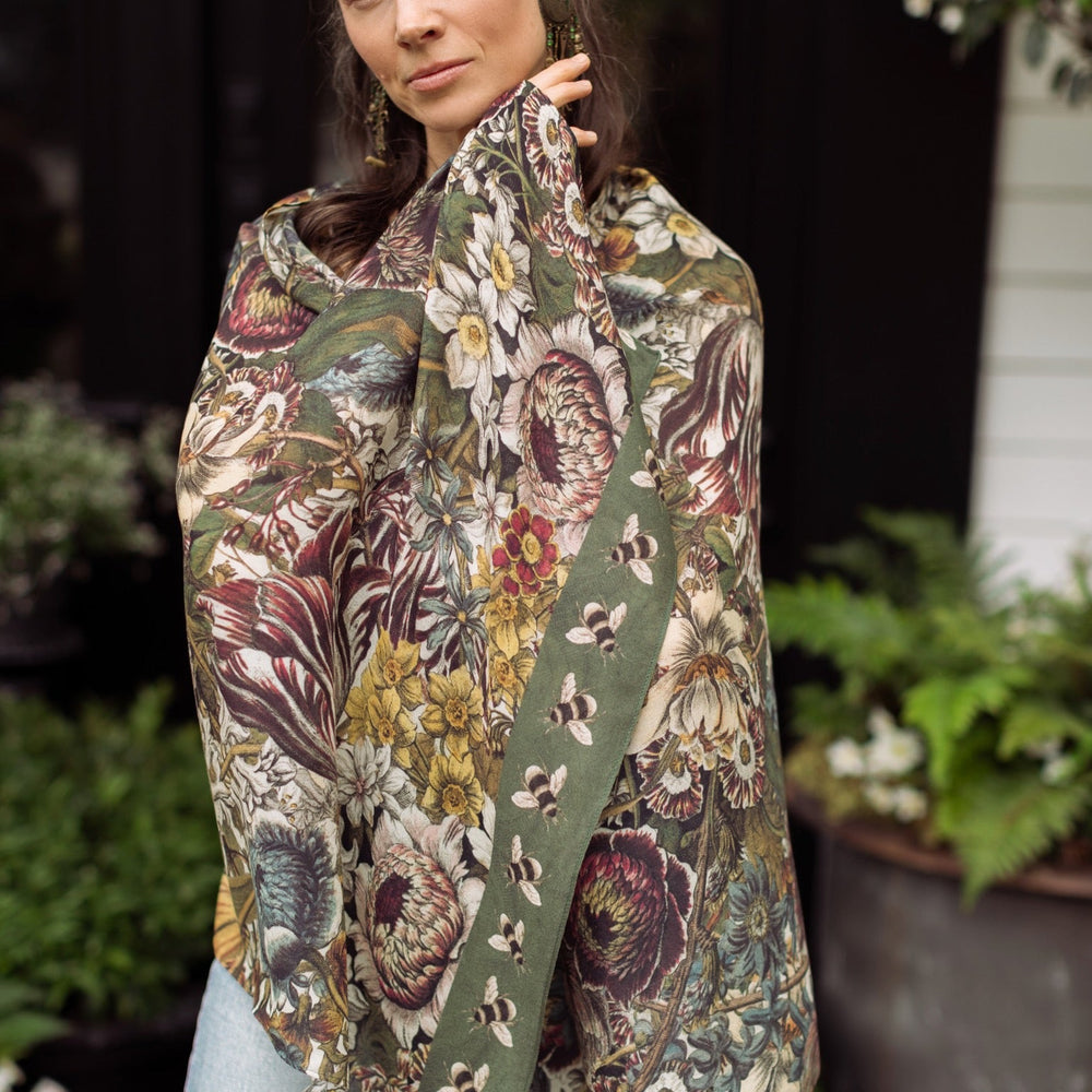 
                  
                    Model wearing soft viscose scarf featuring 1700s March botanical etchings and bumblebee trim from vintage seed catalogue – Market of Stars.
                  
                