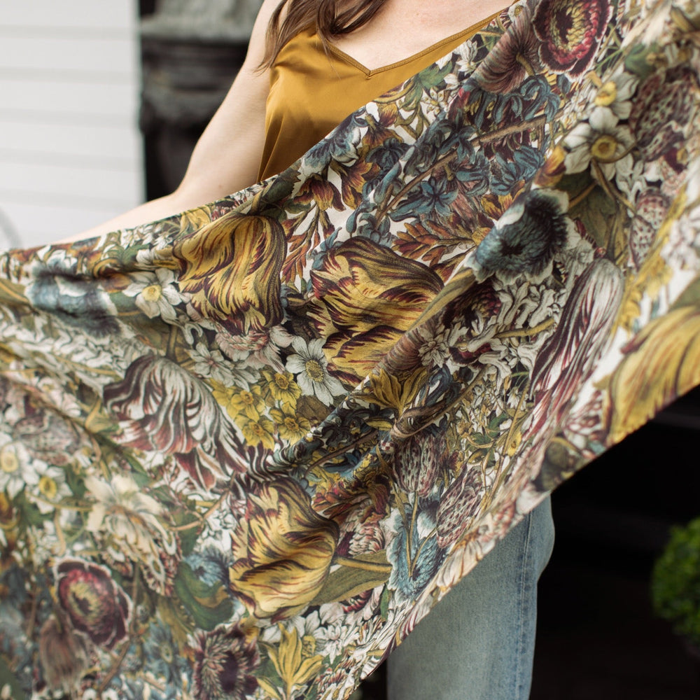 
                  
                    Model wearing soft viscose scarf featuring 1700s March botanical etchings and bumblebee trim from vintage seed catalogue – Market of Stars.
                  
                