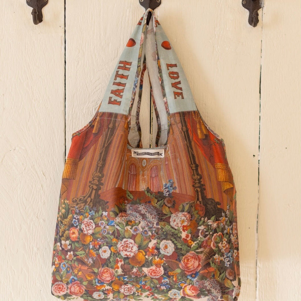 
                  
                    Tote bag featuring joyful 1854 floral artwork, heart-in-hand symbol, and vintage love notes, designed for everyday adventures – Market of Stars
                  
                