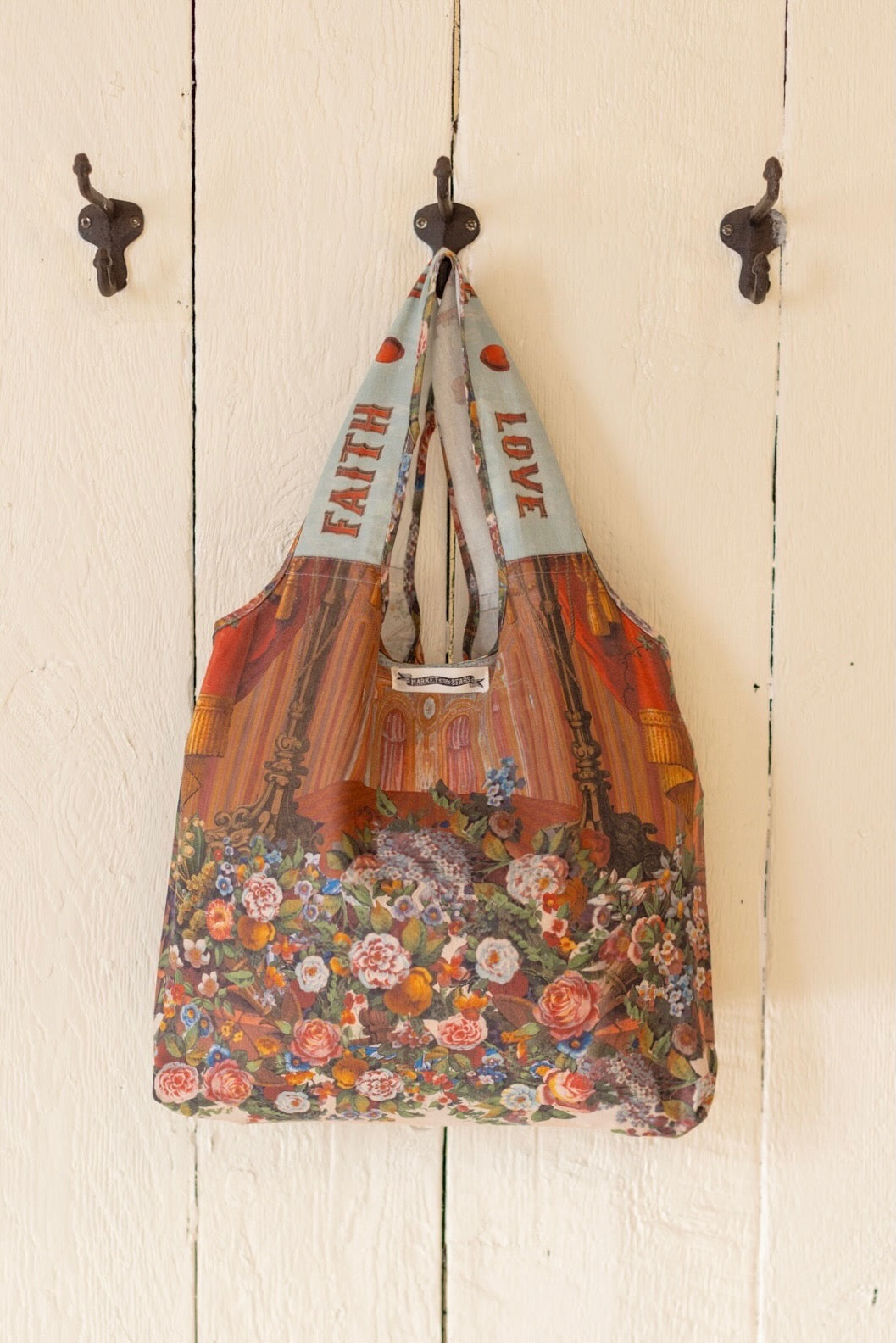 Tote bag featuring joyful 1854 floral artwork, heart-in-hand symbol, and vintage love notes, designed for everyday adventures – Market of Stars
