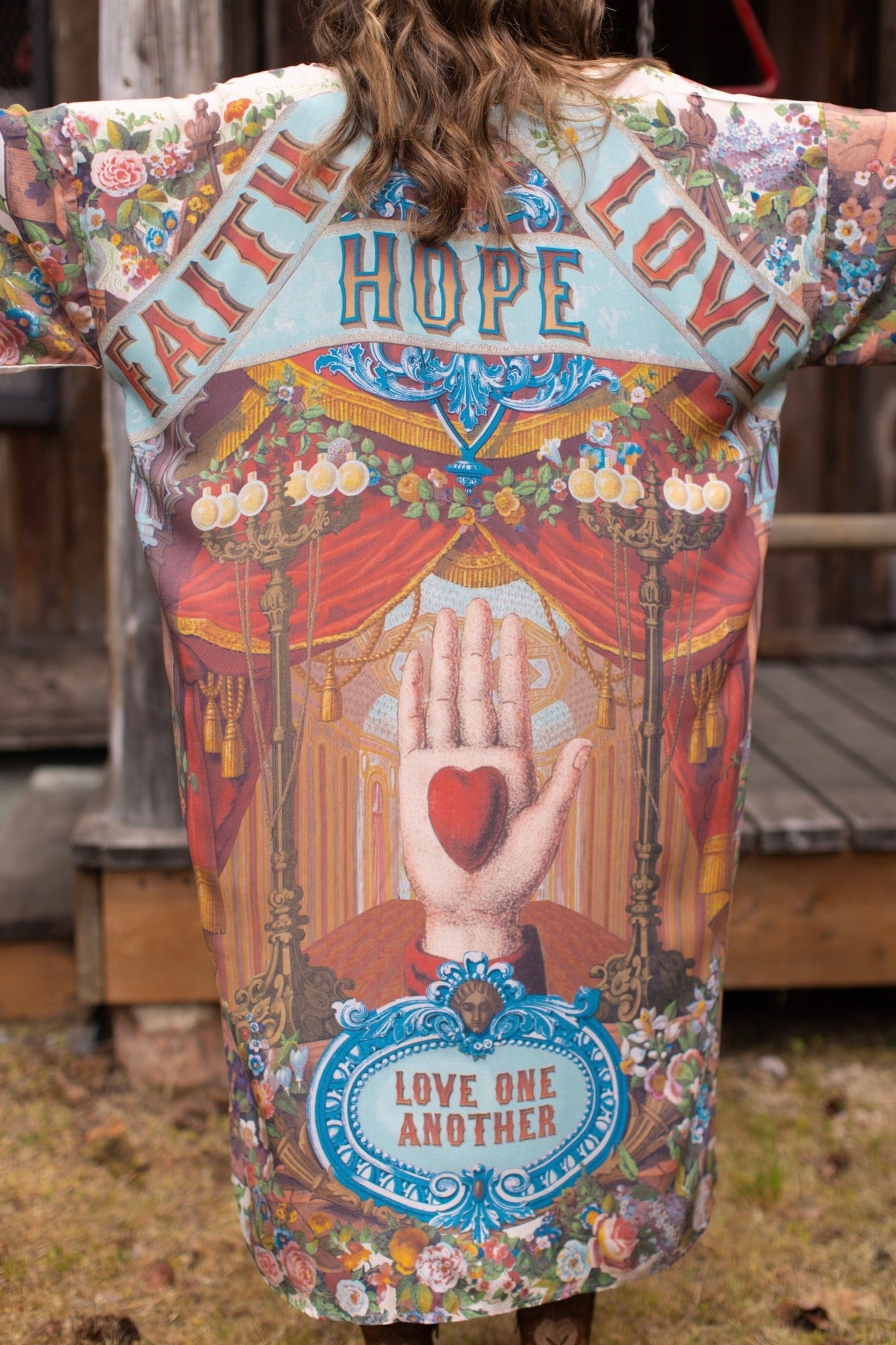 Model wearing romantic full-length kimono featuring joyful 1854 floral art, heart-in-hand symbol, and handwritten messages of love – Market of Stars