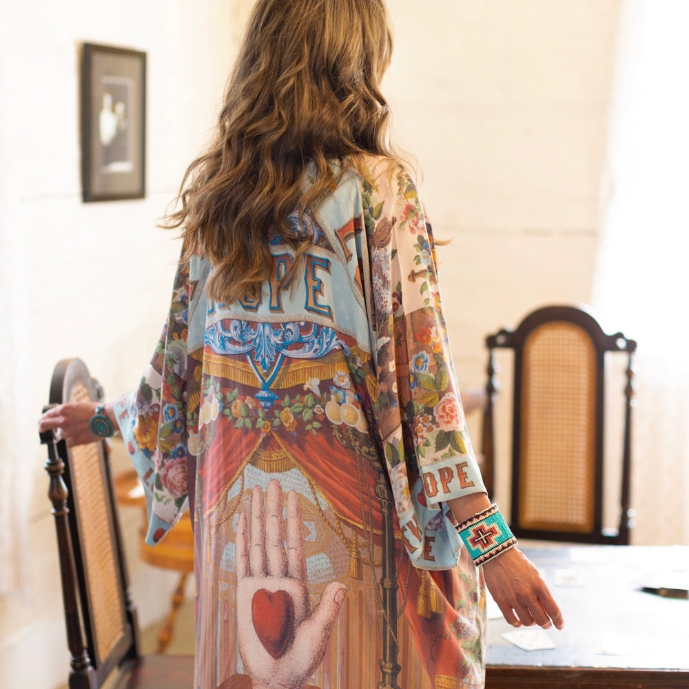 
                  
                    Model wearing romantic full-length kimono featuring joyful 1854 floral art, heart-in-hand symbol, and handwritten messages of love – Market of Stars
                  
                