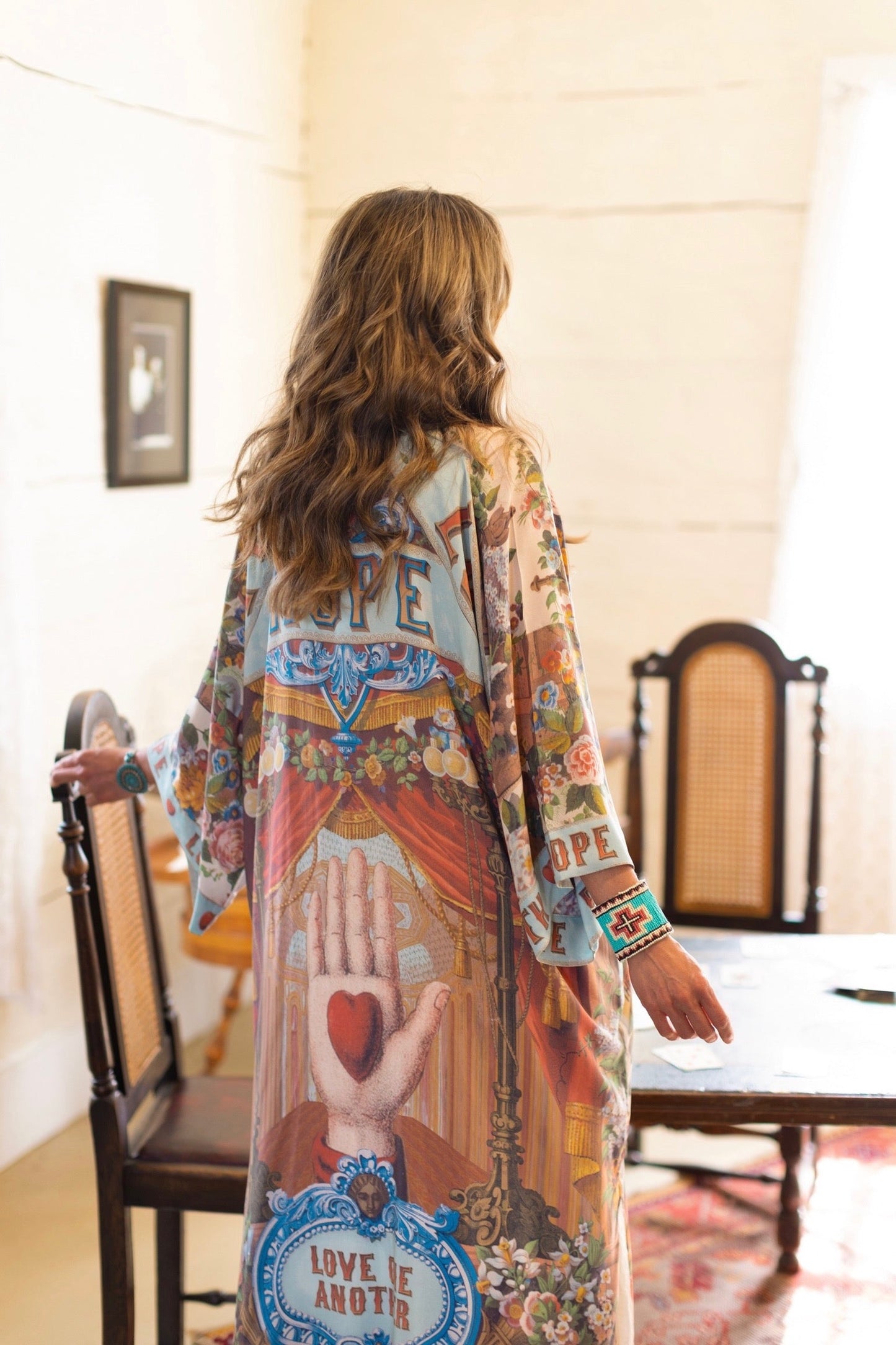 Model wearing romantic full-length kimono featuring joyful 1854 floral art, heart-in-hand symbol, and handwritten messages of love – Market of Stars
