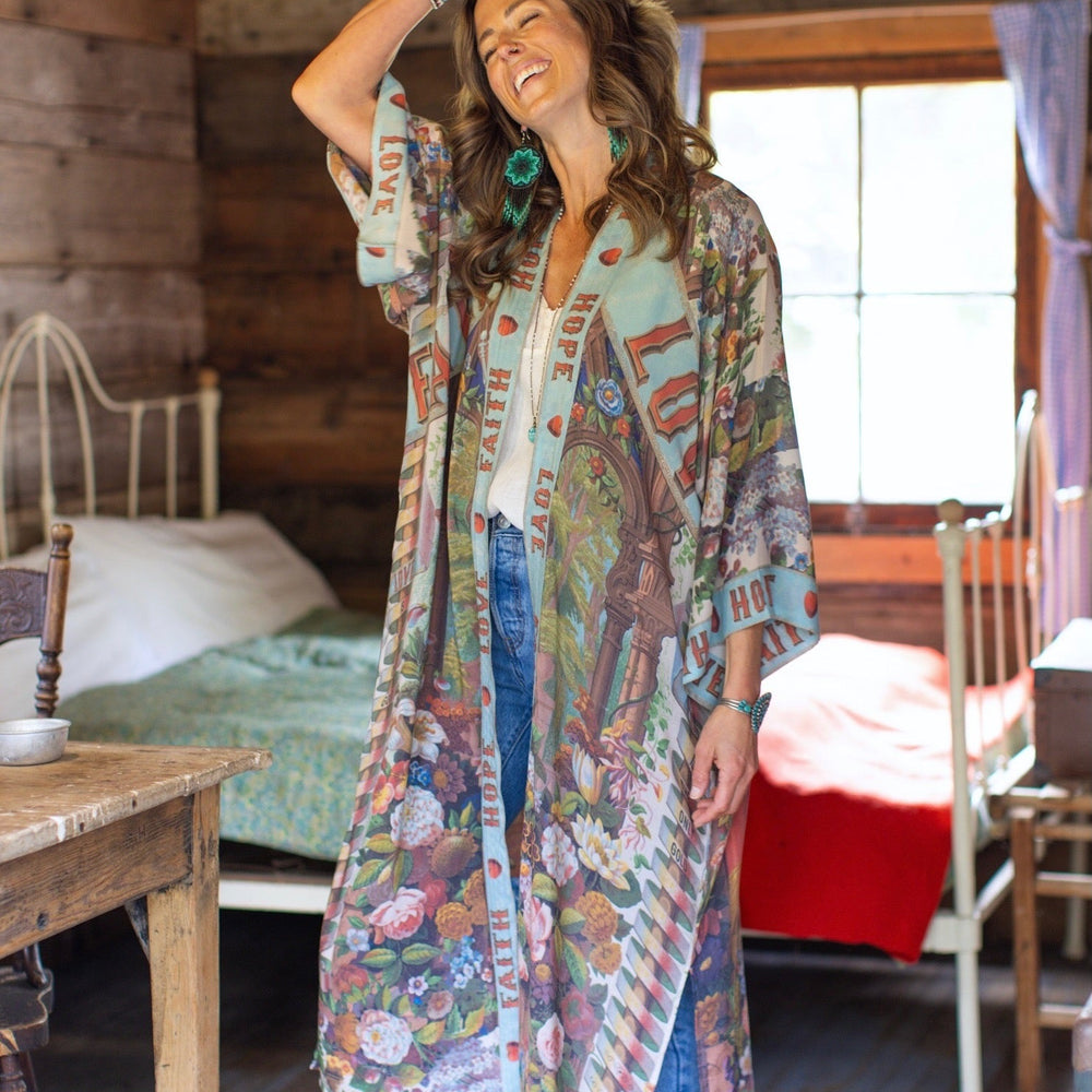 
                  
                    Model wearing romantic full-length kimono featuring joyful 1854 floral art, heart-in-hand symbol, and handwritten messages of love – Market of Stars
                  
                