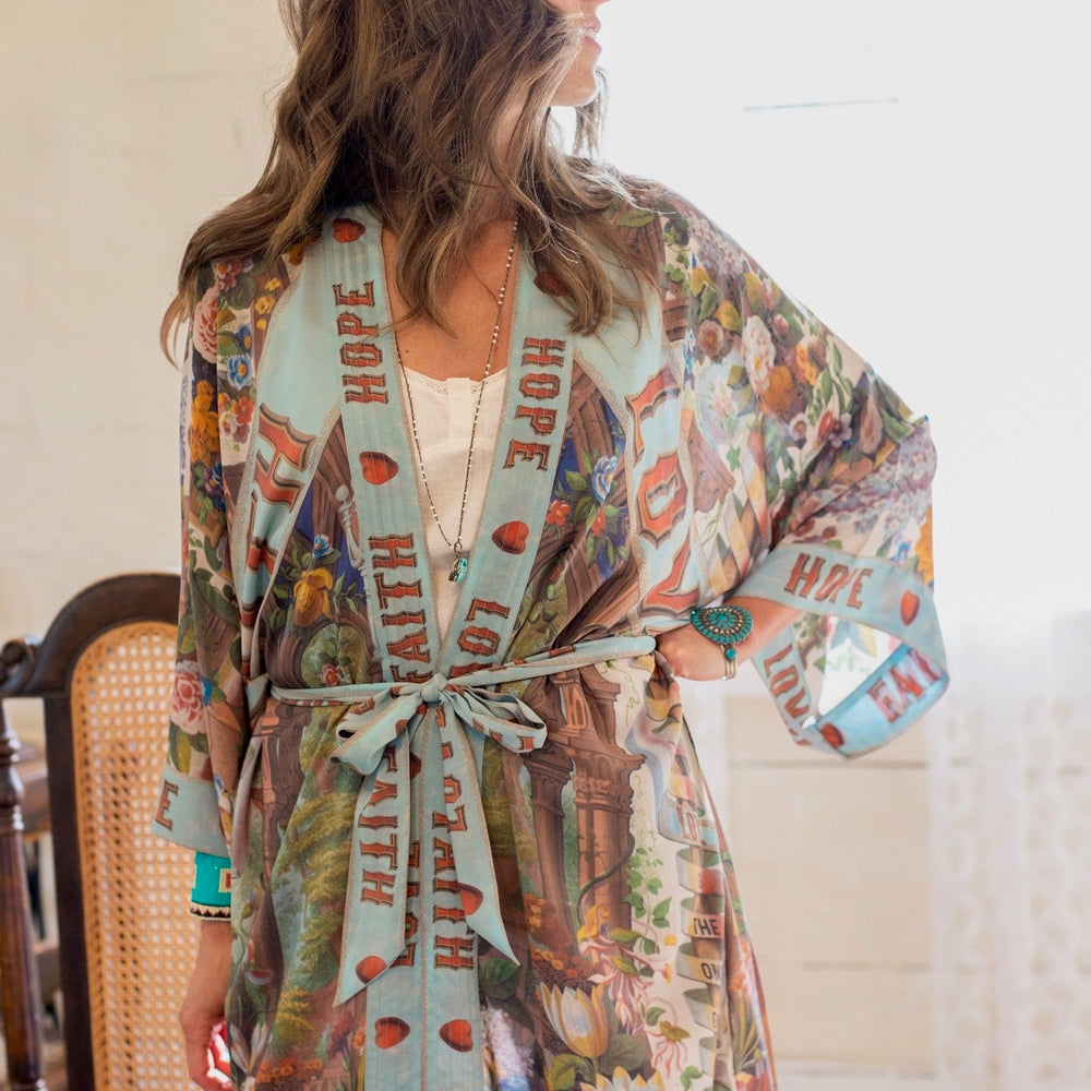 
                  
                    Model wearing romantic full-length kimono featuring joyful 1854 floral art, heart-in-hand symbol, and handwritten messages of love – Market of Stars
                  
                