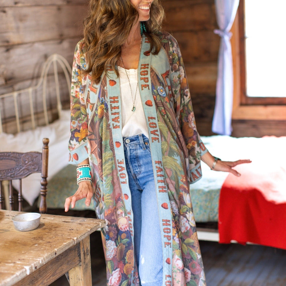 
                  
                    Model wearing romantic full-length kimono featuring joyful 1854 floral art, heart-in-hand symbol, and handwritten messages of love – Market of Stars
                  
                