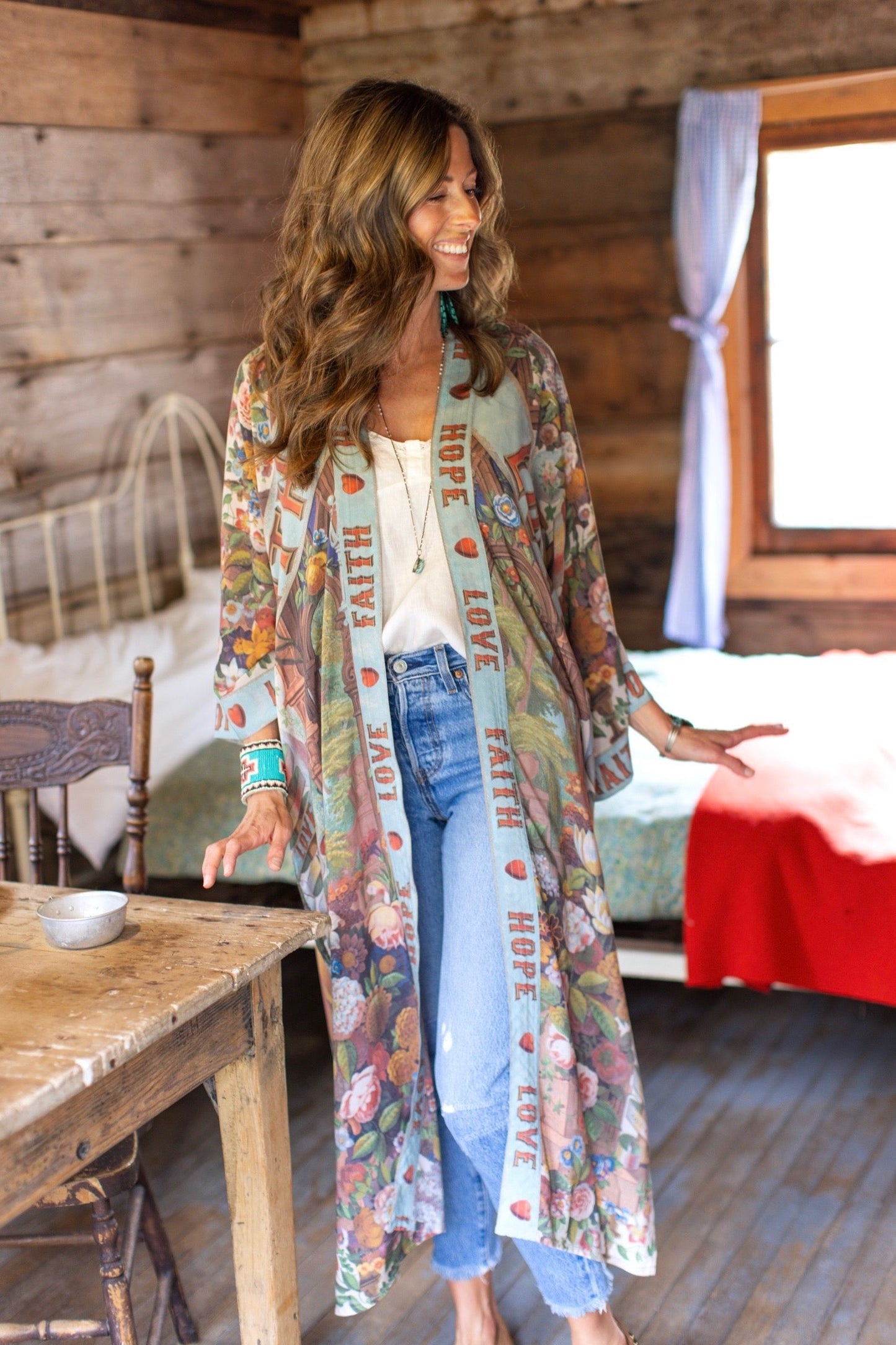 Model wearing romantic full-length kimono featuring joyful 1854 floral art, heart-in-hand symbol, and handwritten messages of love – Market of Stars