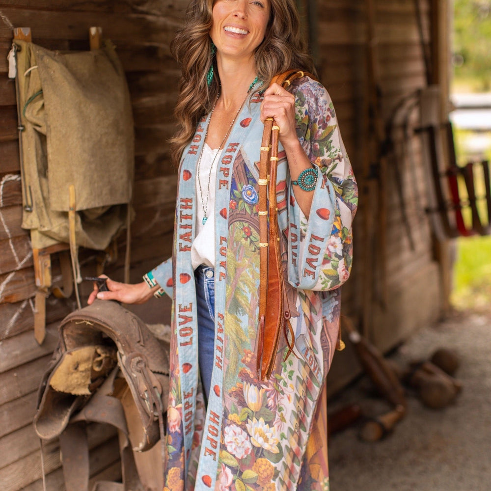 
                  
                    Model wearing romantic full-length kimono featuring joyful 1854 floral art, heart-in-hand symbol, and handwritten messages of love – Market of Stars
                  
                