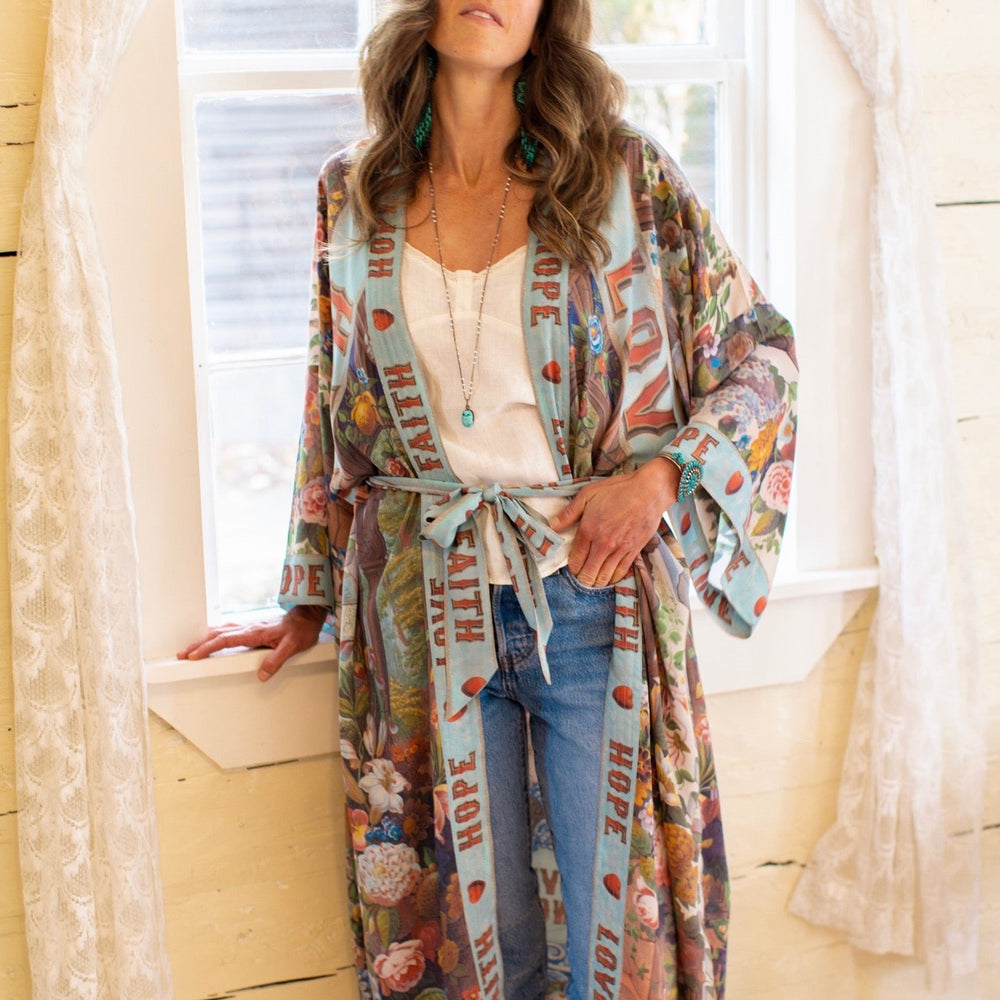 
                  
                    Model wearing romantic full-length kimono featuring joyful 1854 floral art, heart-in-hand symbol, and handwritten messages of love – Market of Stars
                  
                