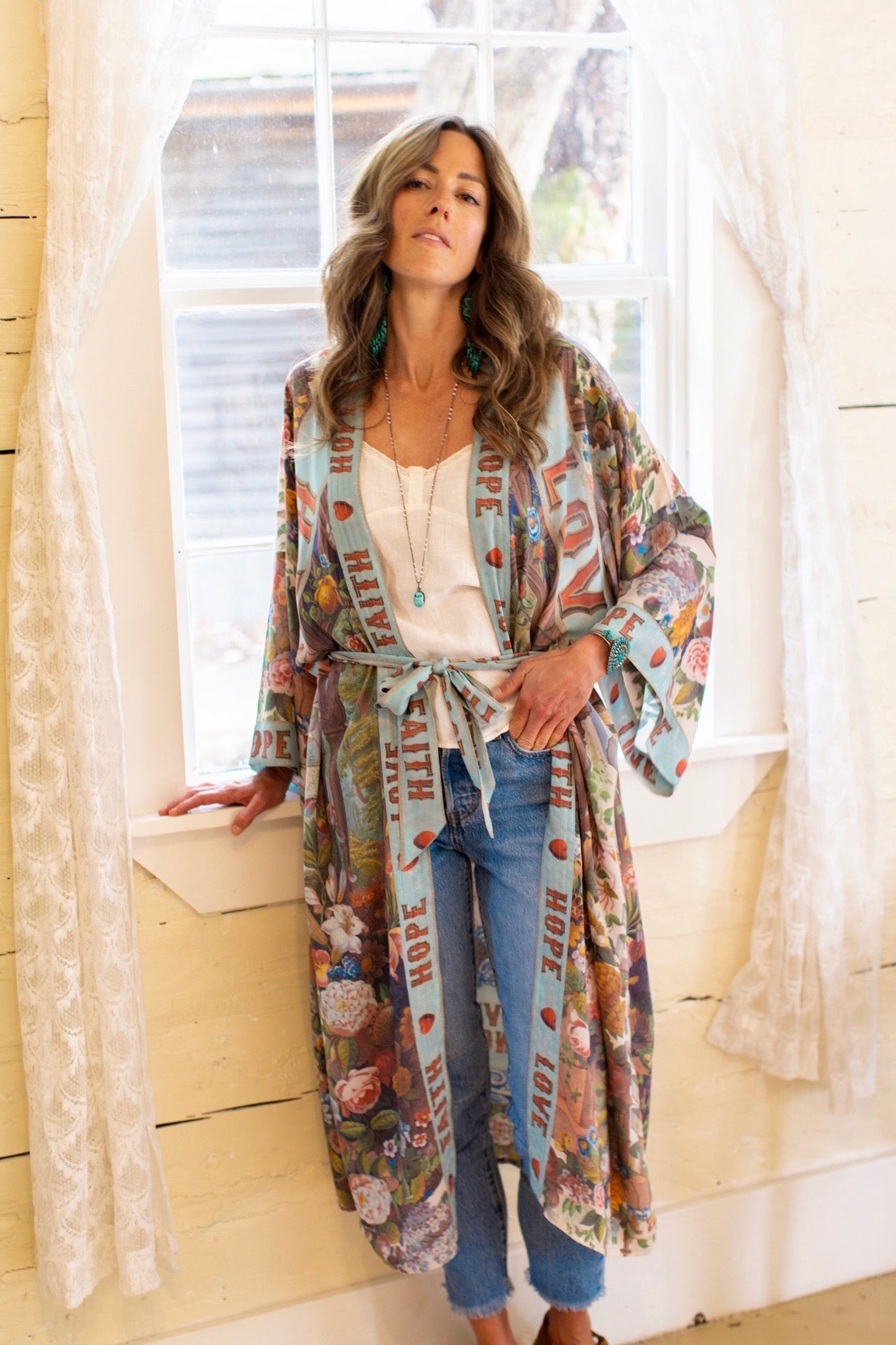 Model wearing romantic full-length kimono featuring joyful 1854 floral art, heart-in-hand symbol, and handwritten messages of love – Market of Stars