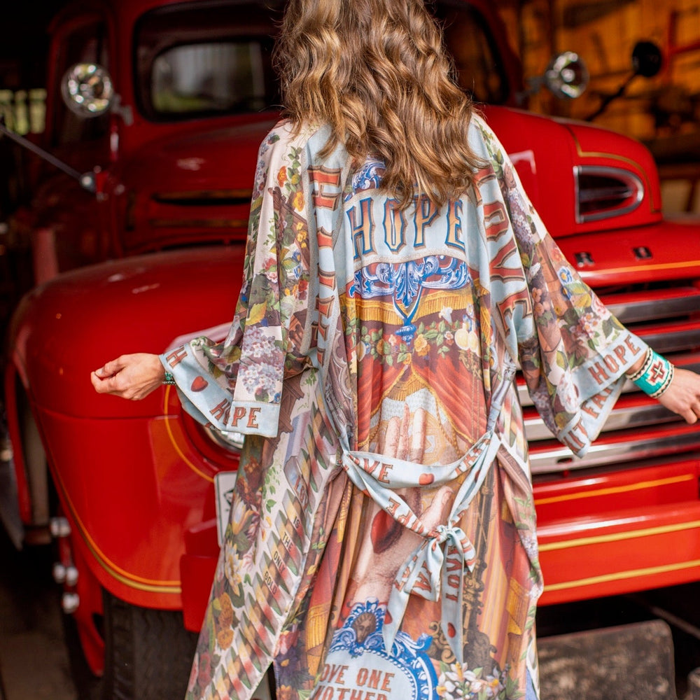 
                  
                    Model wearing romantic full-length kimono featuring joyful 1854 floral art, heart-in-hand symbol, and handwritten messages of love – Market of Stars
                  
                