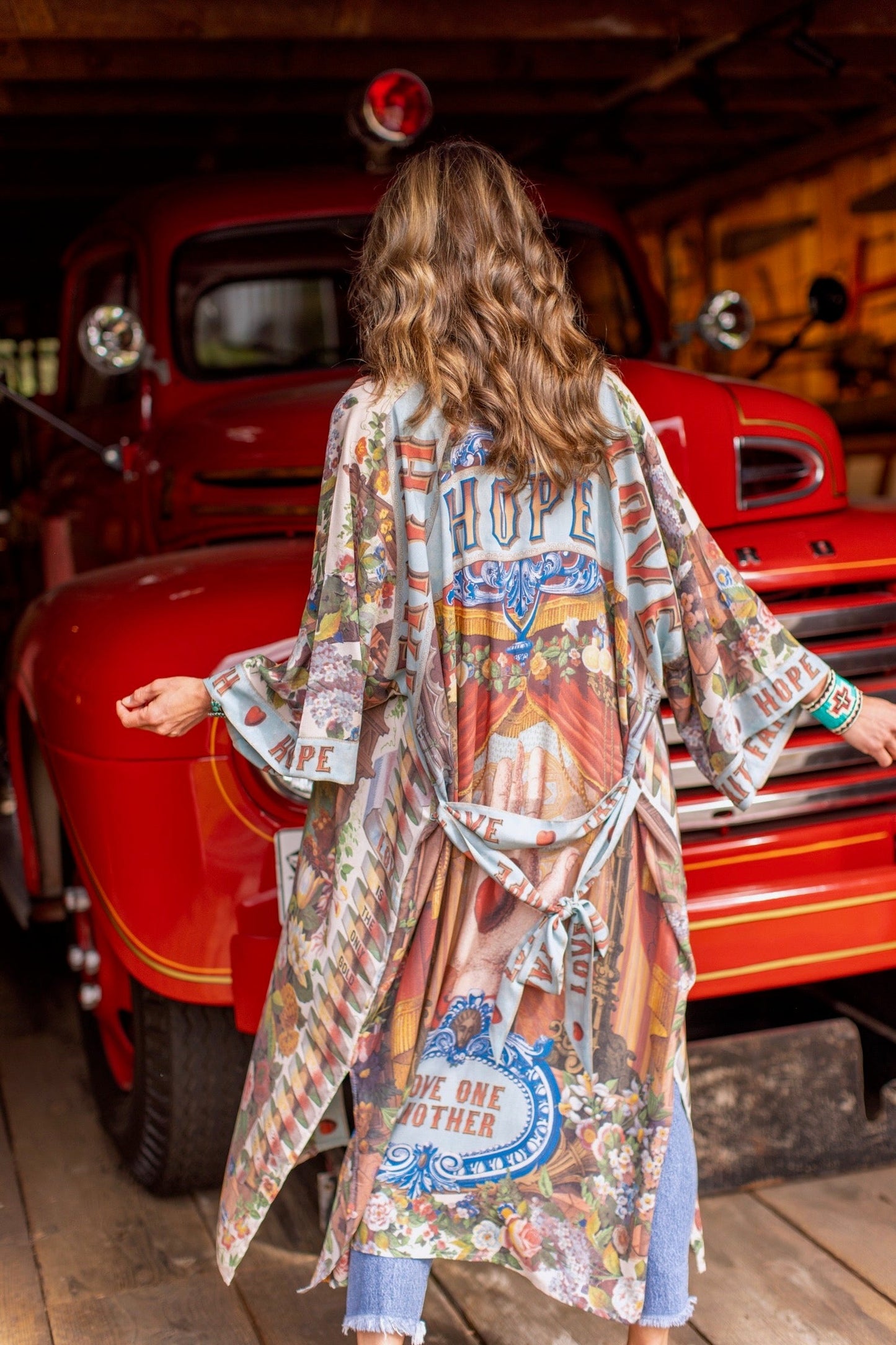 Model wearing romantic full-length kimono featuring joyful 1854 floral art, heart-in-hand symbol, and handwritten messages of love – Market of Stars