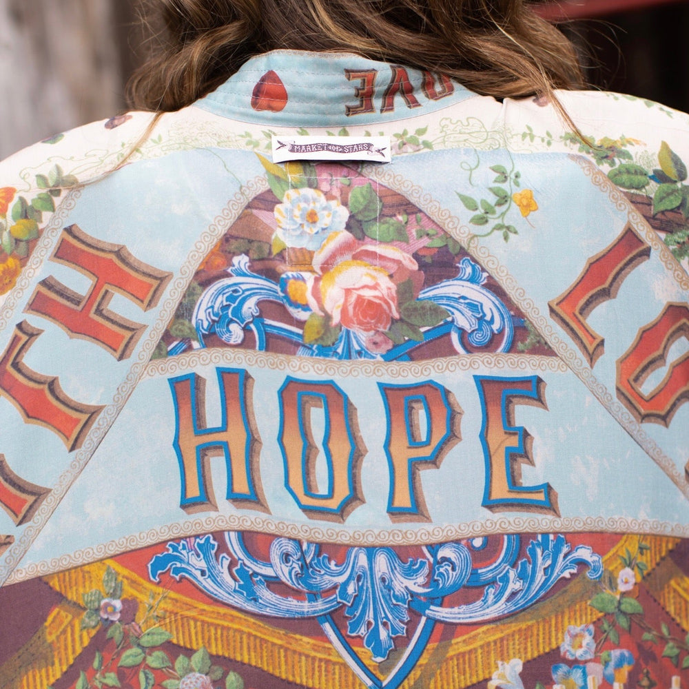 
                  
                    Model wearing romantic full-length kimono featuring joyful 1854 floral art, heart-in-hand symbol, and handwritten messages of love – Market of Stars
                  
                