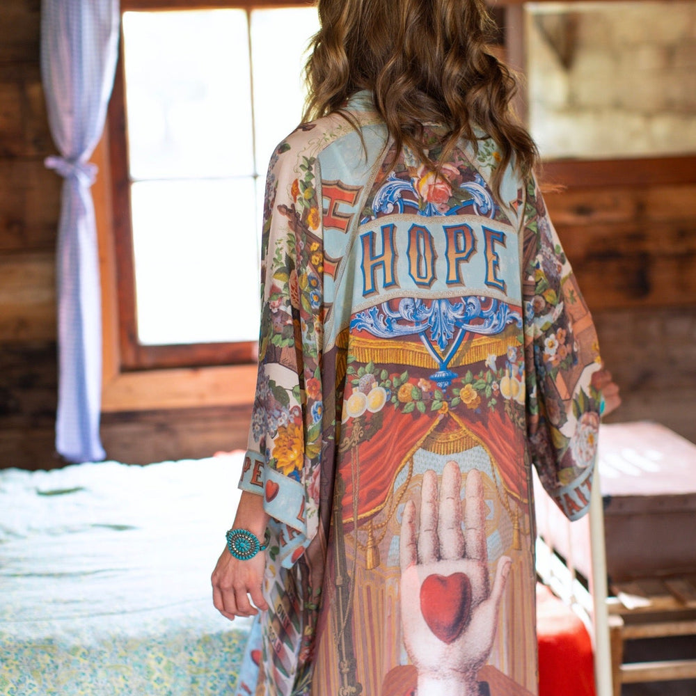 
                  
                    Model wearing romantic full-length kimono featuring joyful 1854 floral art, heart-in-hand symbol, and handwritten messages of love – Market of Stars
                  
                