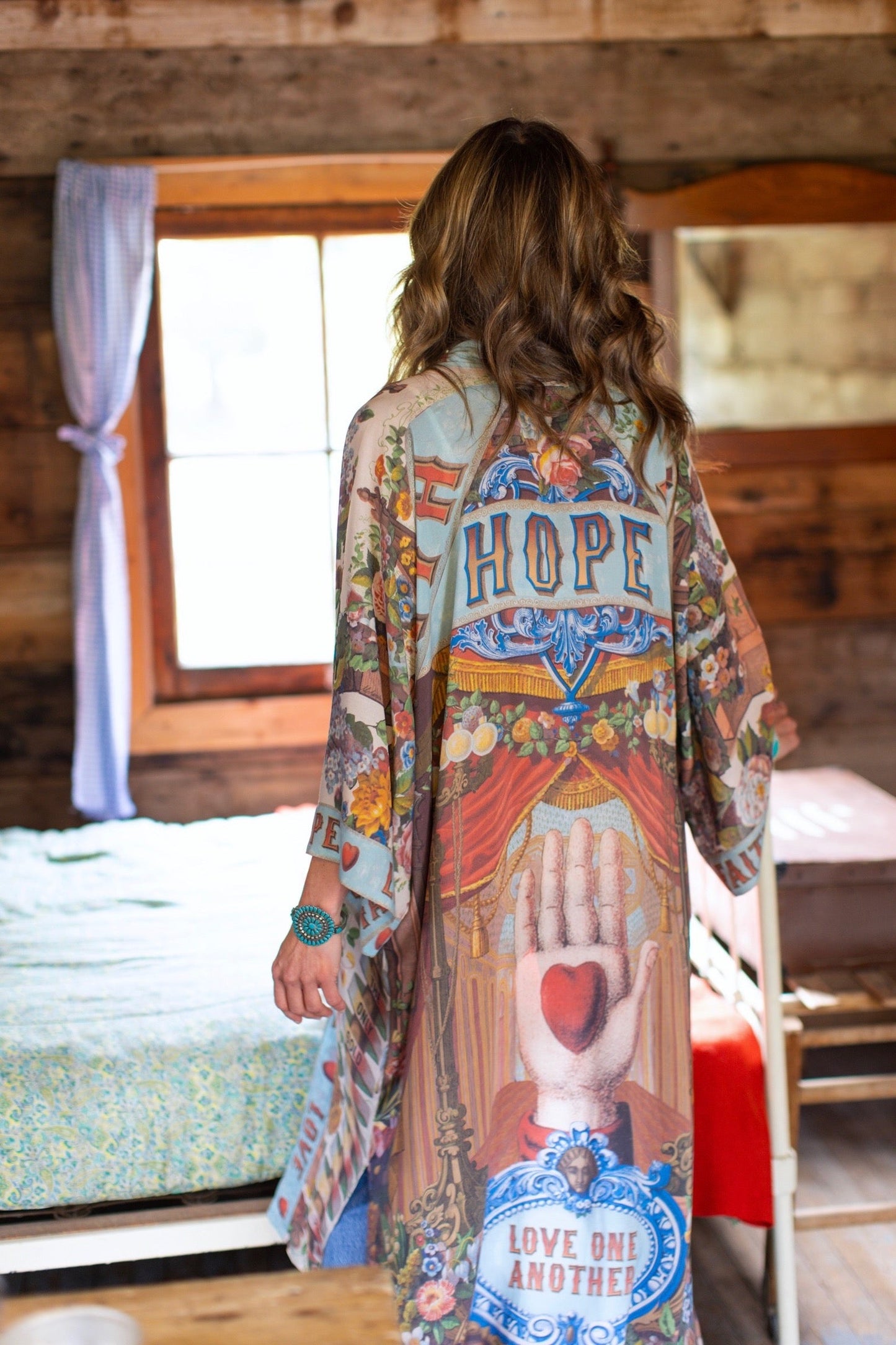 Model wearing romantic full-length kimono featuring joyful 1854 floral art, heart-in-hand symbol, and handwritten messages of love – Market of Stars