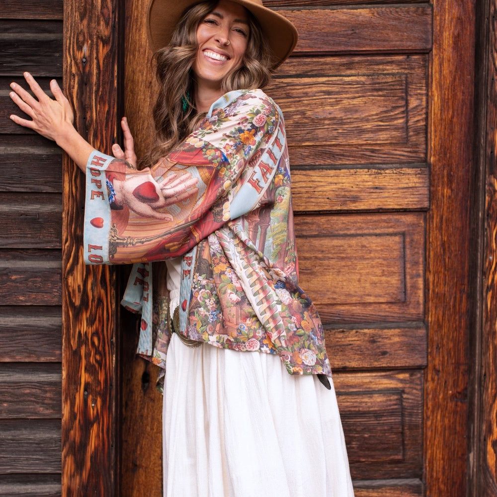 
                  
                    Model in cropped kimono featuring joyful 1854 floral art, heart-in-hand symbol, and handwritten love notes – Market of Stars.
                  
                