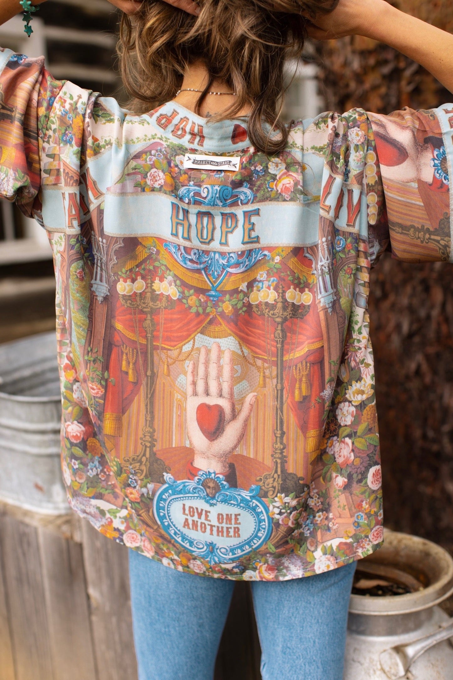 Model in cropped kimono featuring joyful 1854 floral art, heart-in-hand symbol, and handwritten love notes – Market of Stars.