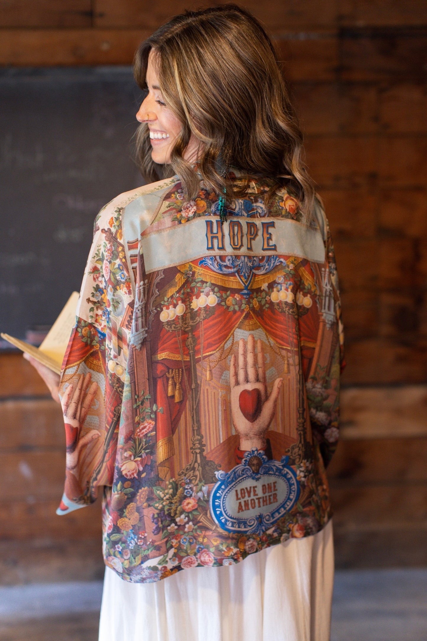 Model in cropped kimono featuring joyful 1854 floral art, heart-in-hand symbol, and handwritten love notes – Market of Stars.
