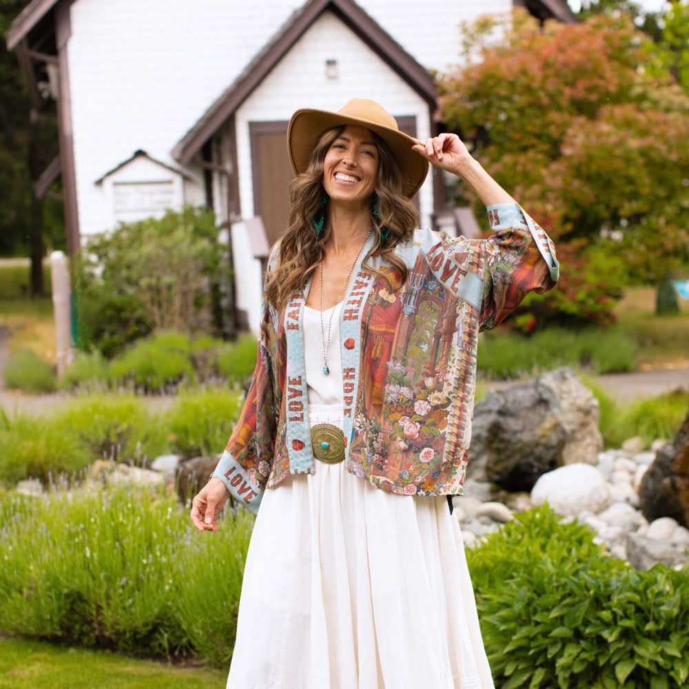 
                  
                    Model in cropped kimono featuring joyful 1854 floral art, heart-in-hand symbol, and handwritten love notes – Market of Stars.
                  
                