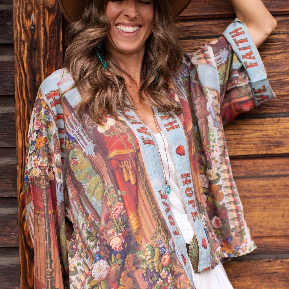 
                  
                    Model in cropped kimono featuring joyful 1854 floral art, heart-in-hand symbol, and handwritten love notes – Market of Stars.
                  
                