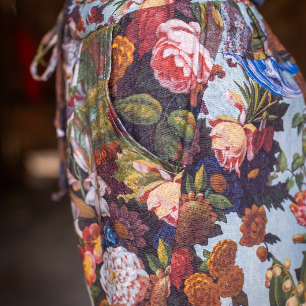 
                  
                    Model wearing linen blend artist pants with 1854 floral art, heart-in-hand symbol, and “Love one another” handwritten script – Market of Stars.
                  
                