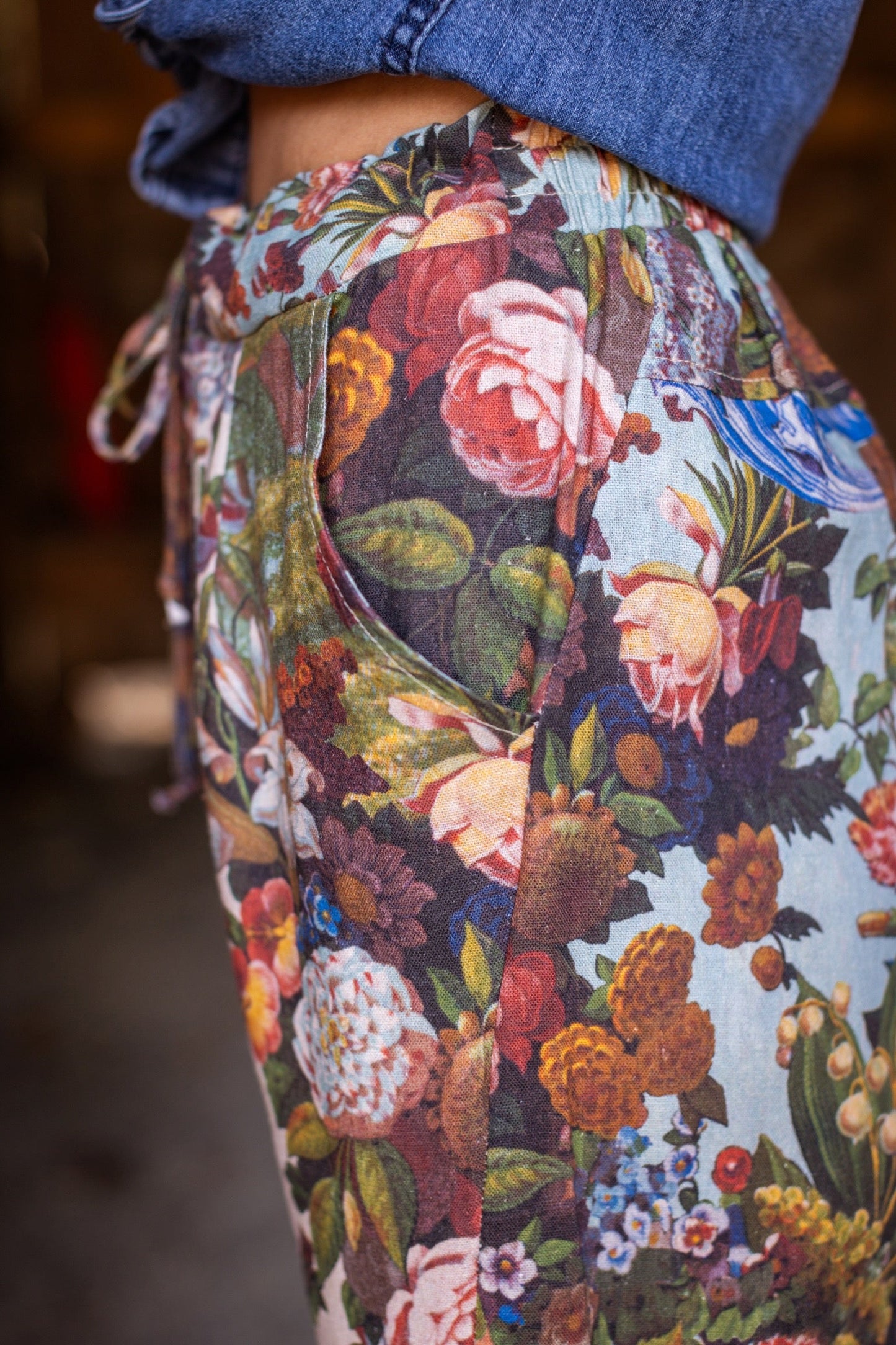 Model wearing linen blend artist pants with 1854 floral art, heart-in-hand symbol, and “Love one another” handwritten script – Market of Stars.