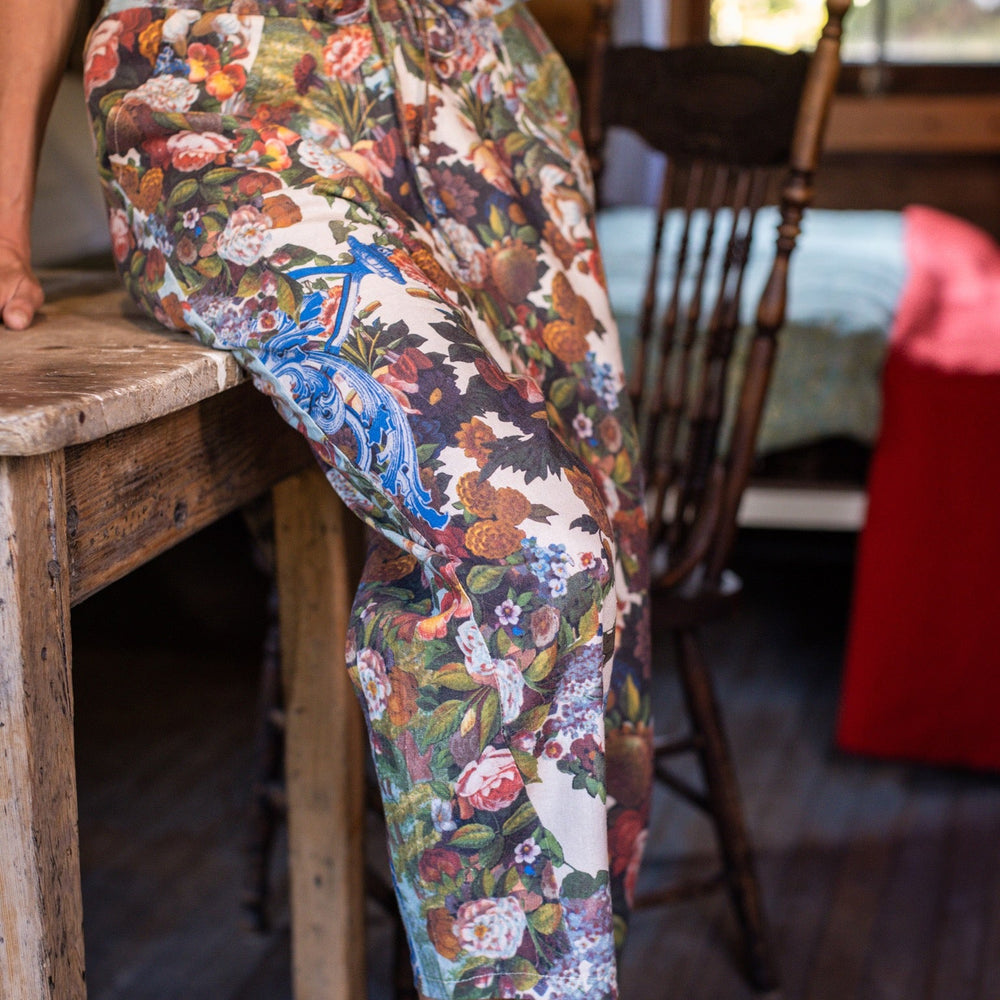 
                  
                    Model wearing linen blend artist pants with 1854 floral art, heart-in-hand symbol, and “Love one another” handwritten script – Market of Stars.
                  
                