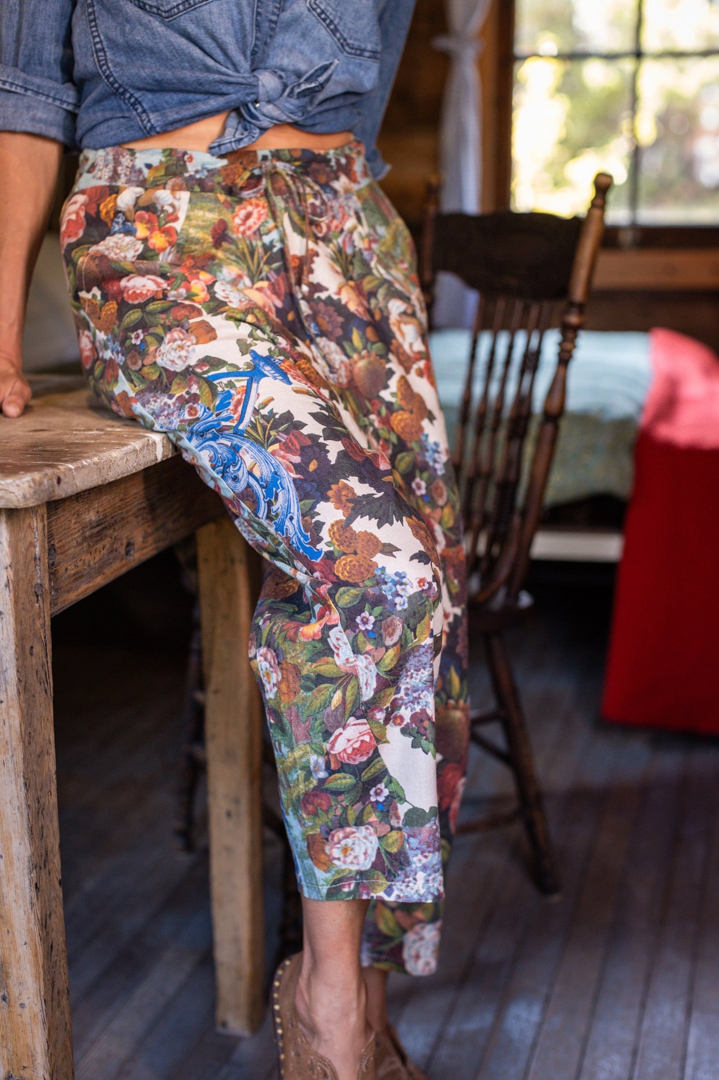Model wearing linen blend artist pants with 1854 floral art, heart-in-hand symbol, and “Love one another” handwritten script – Market of Stars.