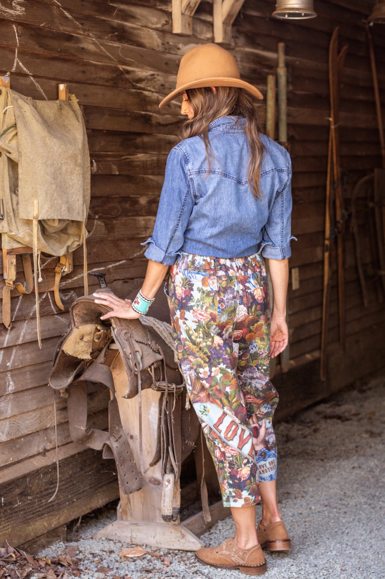 Model wearing linen blend artist pants with 1854 floral art, heart-in-hand symbol, and “Love one another” handwritten script – Market of Stars.