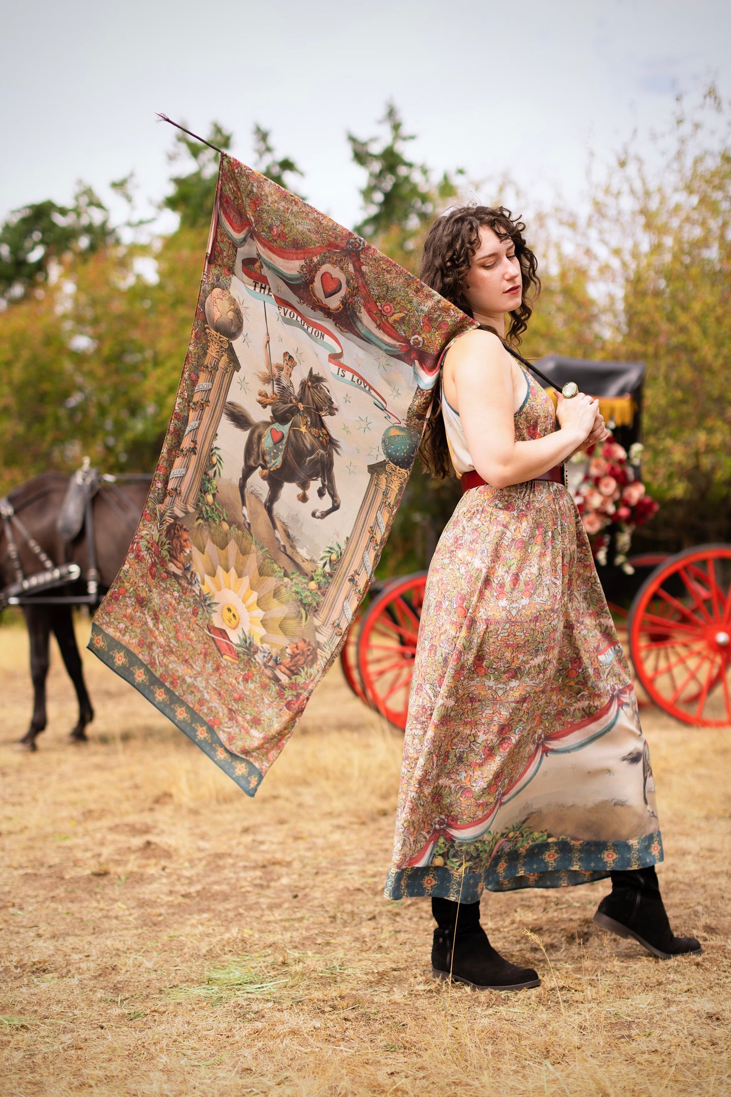 Model wearing a bamboo-viscose scarf ft. a woman astride a rearing horse, soft vintage florals, rosettes and lithographs from the 1800's - Market of Stars