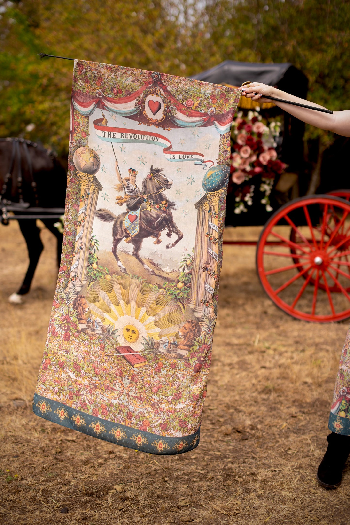 Model wearing a bamboo-viscose scarf ft. a woman astride a rearing horse, soft vintage florals, rosettes and lithographs from the 1800's - Market of Stars