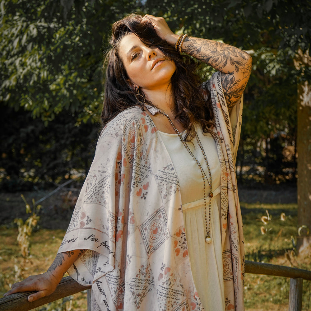 
                  
                    Model wearing romantic kimono with patchwork pattern made from a 200-year-old puzzle purse love letter featuring handwritten poetry and vintage florals – Market of Stars
                  
                