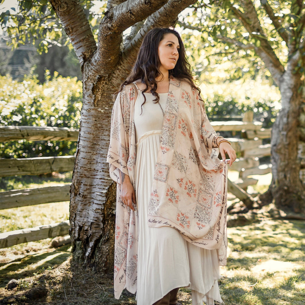 
                  
                    Model wearing romantic kimono with patchwork pattern made from a 200-year-old puzzle purse love letter featuring handwritten poetry and vintage florals – Market of Stars
                  
                