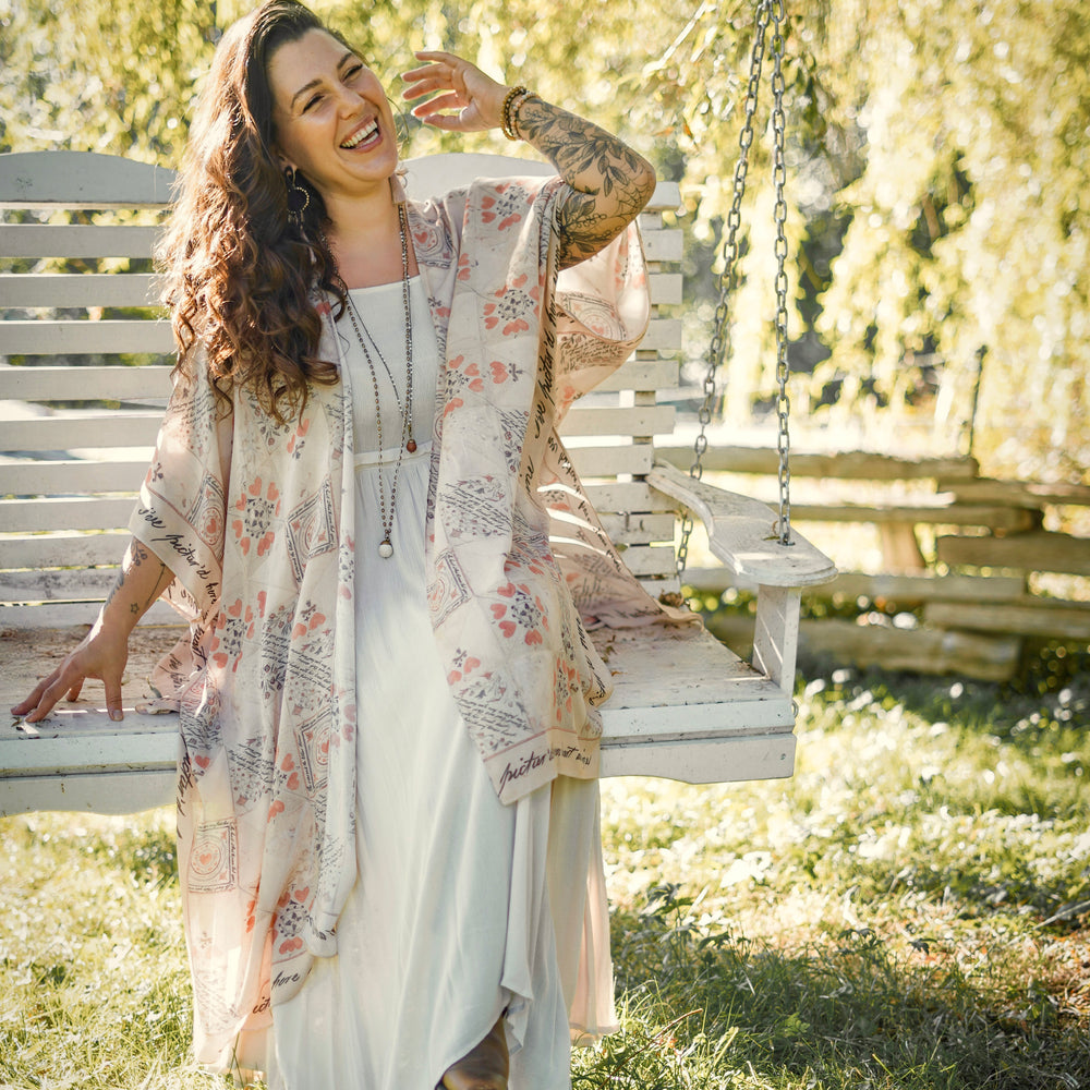 
                  
                    Model wearing romantic kimono with patchwork pattern made from a 200-year-old puzzle purse love letter featuring handwritten poetry and vintage florals – Market of Stars
                  
                