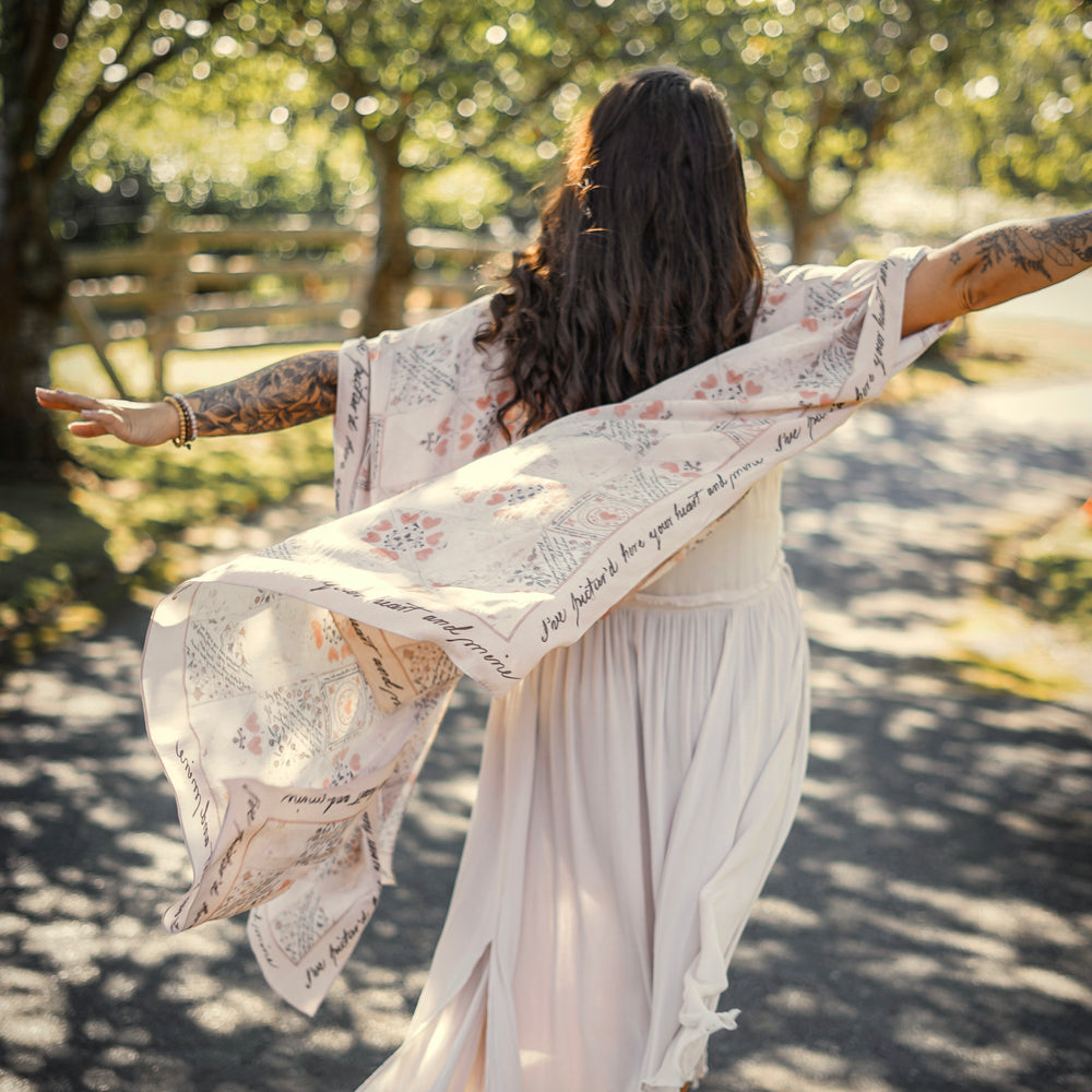 
                  
                    Model wearing romantic kimono with patchwork pattern made from a 200-year-old puzzle purse love letter featuring handwritten poetry and vintage florals – Market of Stars
                  
                