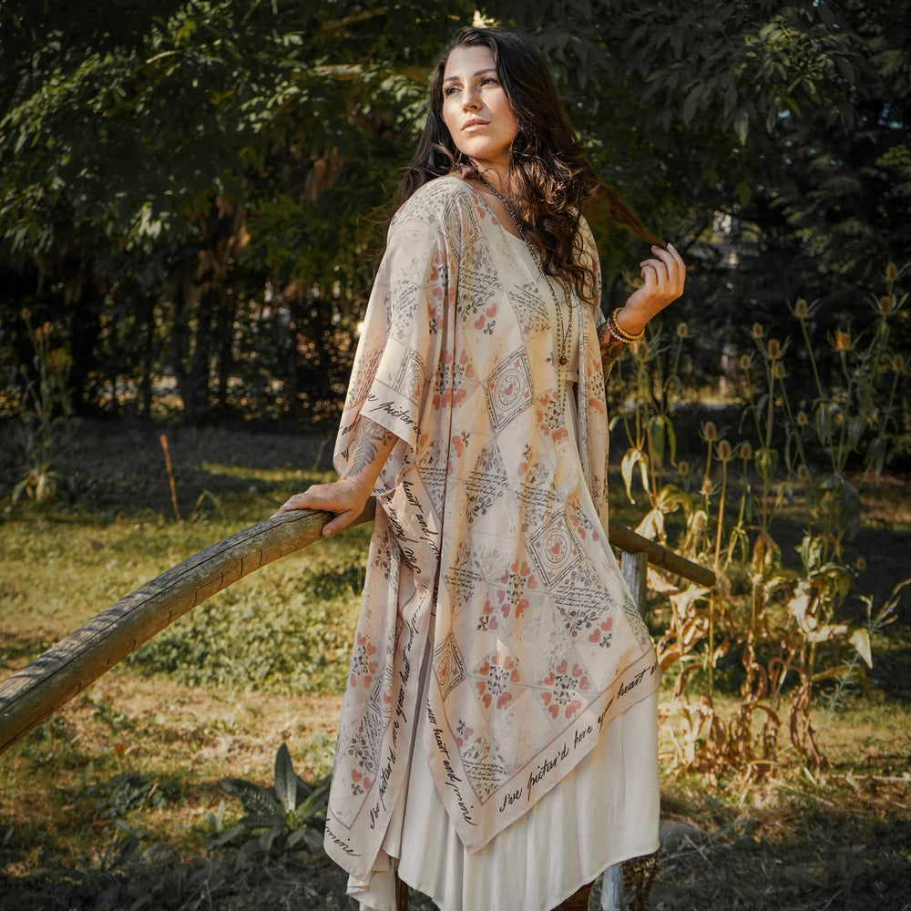 
                  
                    Model wearing romantic kimono with patchwork pattern made from a 200-year-old puzzle purse love letter featuring handwritten poetry and vintage florals – Market of Stars
                  
                