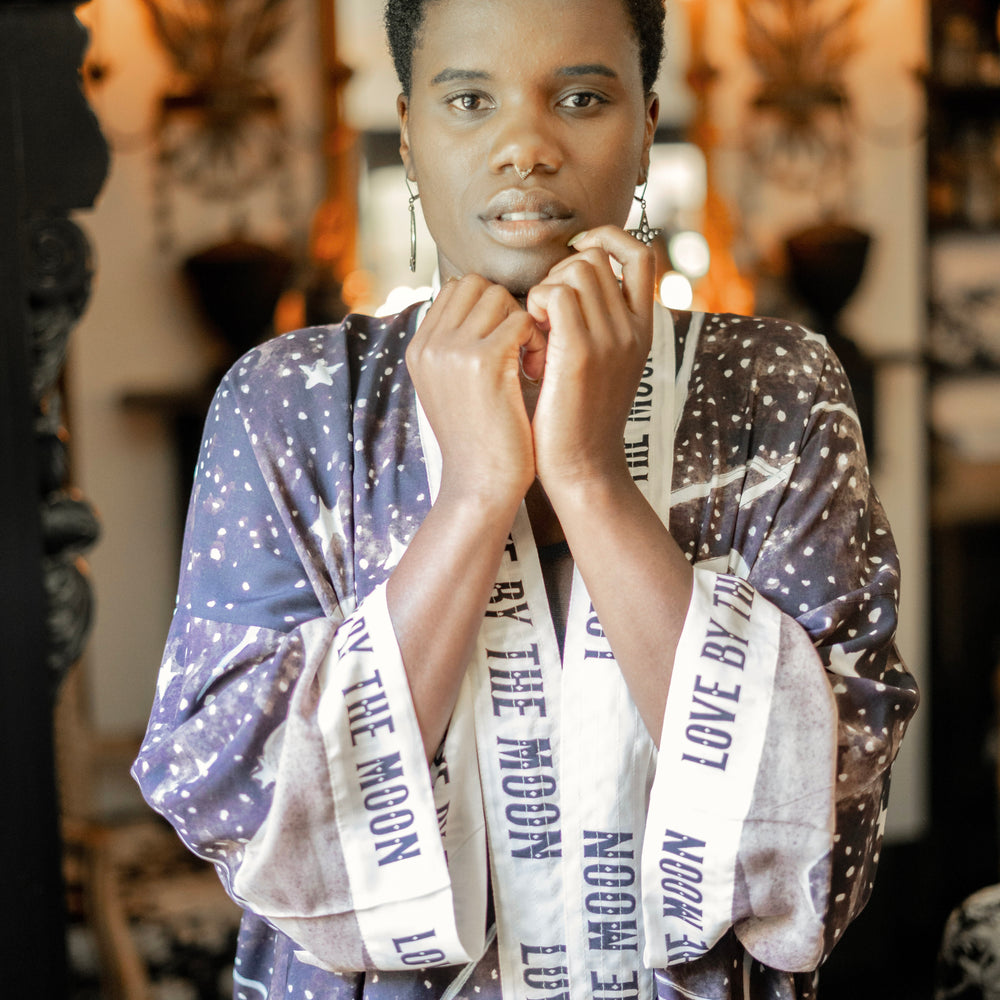 
                  
                    Model wearing Love By The Moon Kimono featuring sepia tones, vintage moon illustration, and retro typography inspired by early 1900s photo props – Market of Stars
                  
                