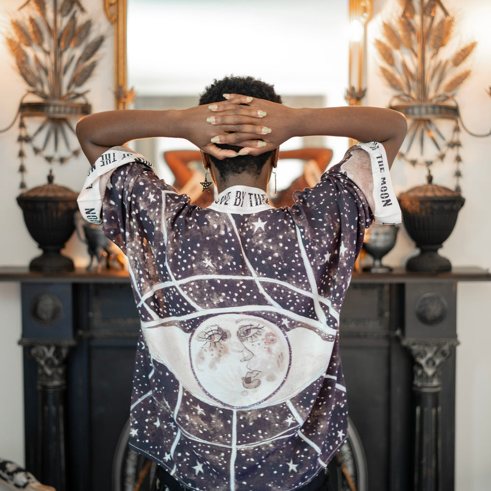 
                  
                    Model wearing Love By The Moon Kimono featuring sepia tones, vintage moon illustration, and retro typography inspired by early 1900s photo props – Market of Stars
                  
                