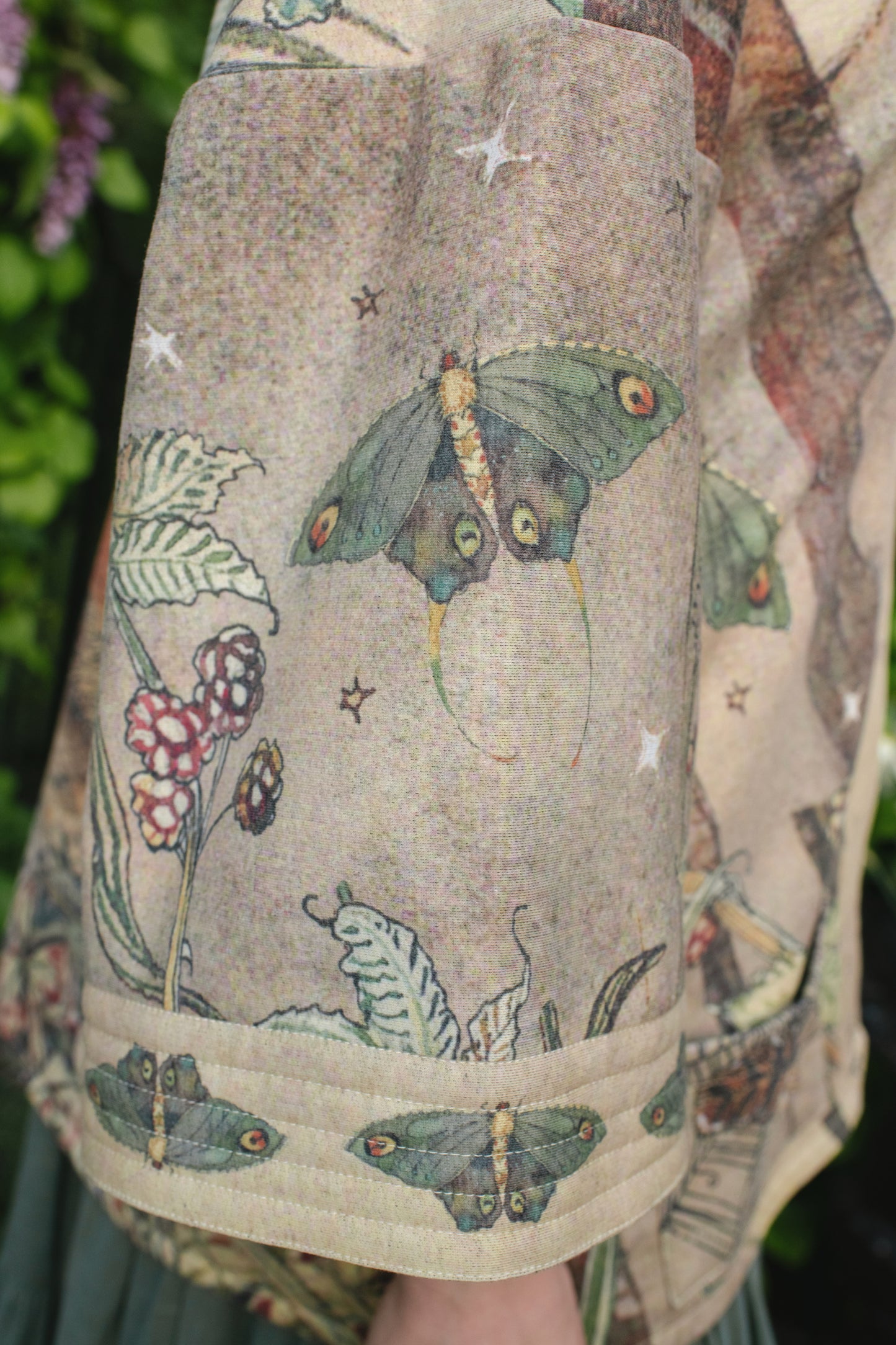 Model wearing the Lovelight Cottage Cardigan ft artwork by world-renowned illustrator Charles van Sandwyk - Market of Stars