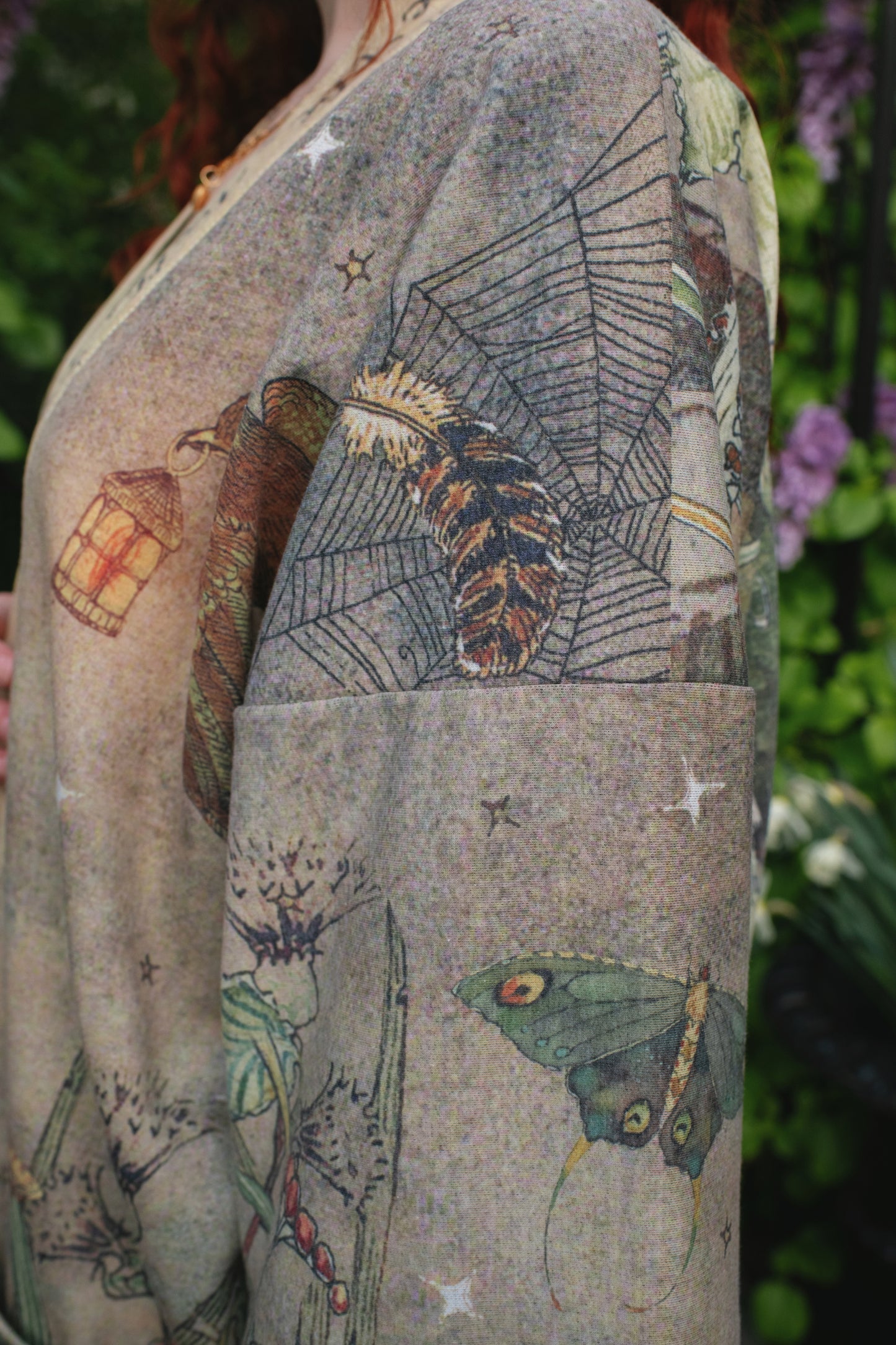 Model wearing the Lovelight Cottage Cardigan ft artwork by world-renowned illustrator Charles van Sandwyk - Market of Stars
