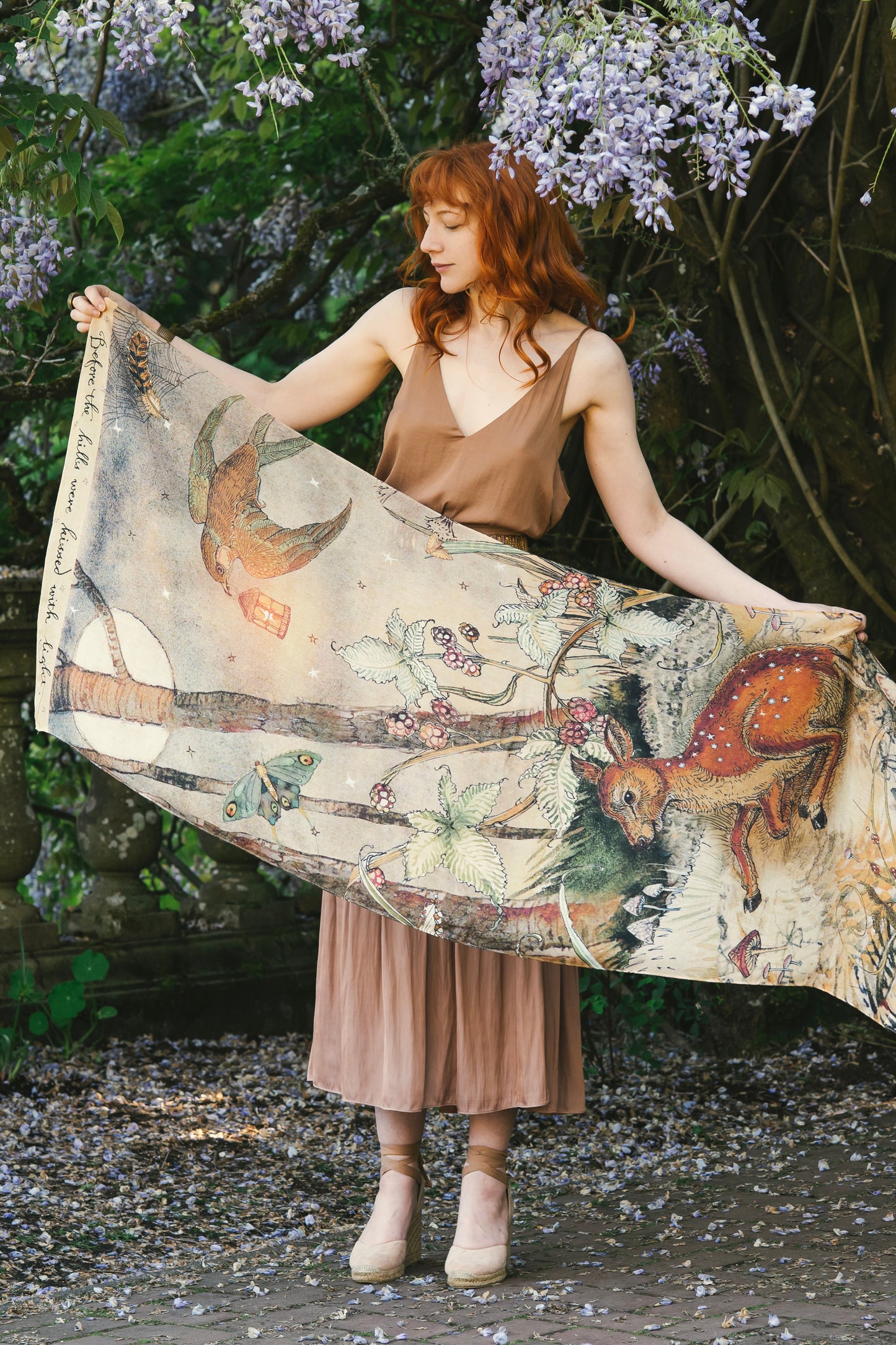 Model wearing an enchanting scarf featuring Charles van Sandwyck's illustrations, crafted from airy bamboo-based viscose with a touch of whimsical magic - Market of Stars