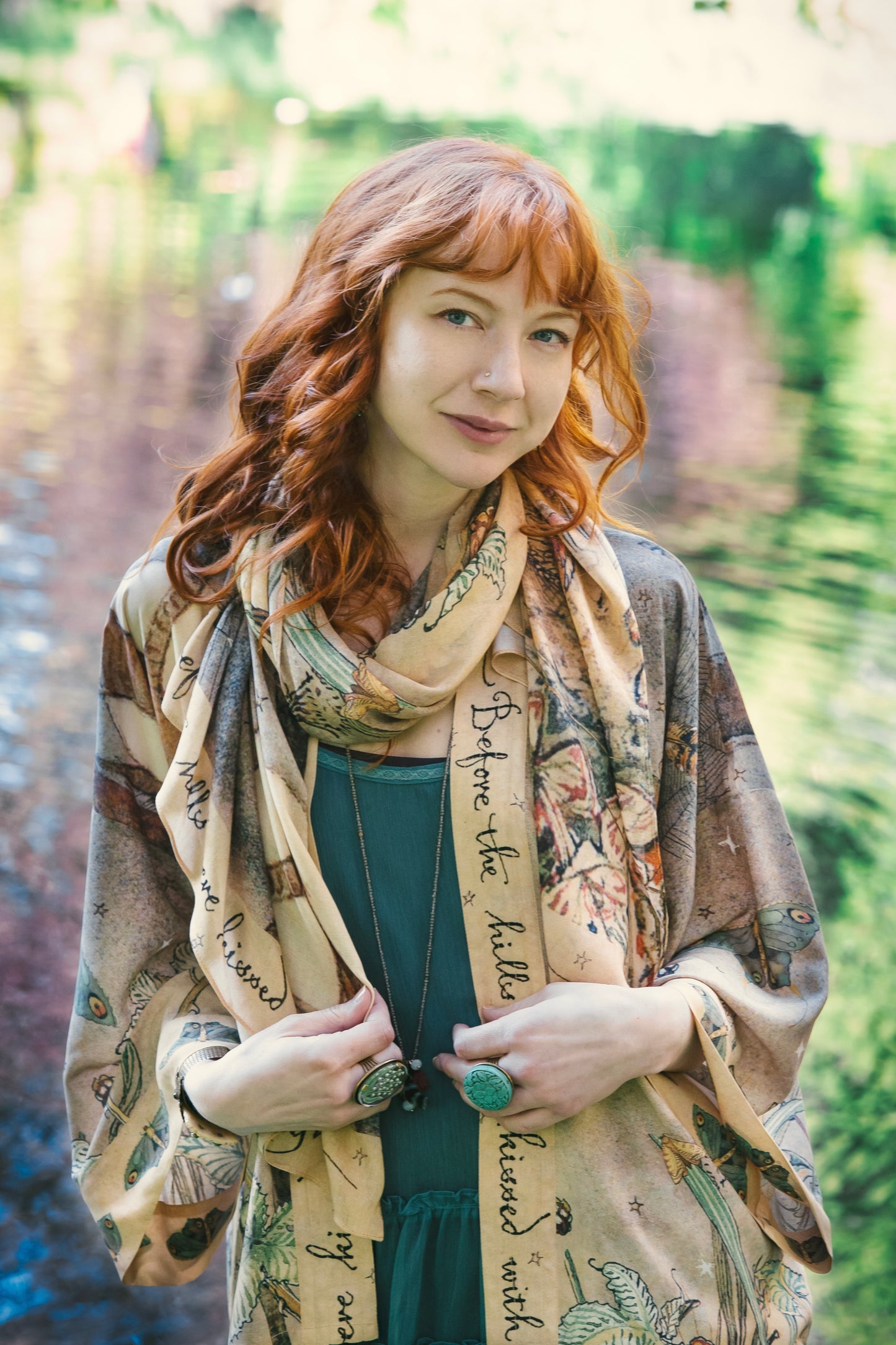 Model wearing an enchanting scarf featuring Charles van Sandwyck's illustrations, crafted from airy bamboo-based viscose with a touch of whimsical magic - Market of Stars